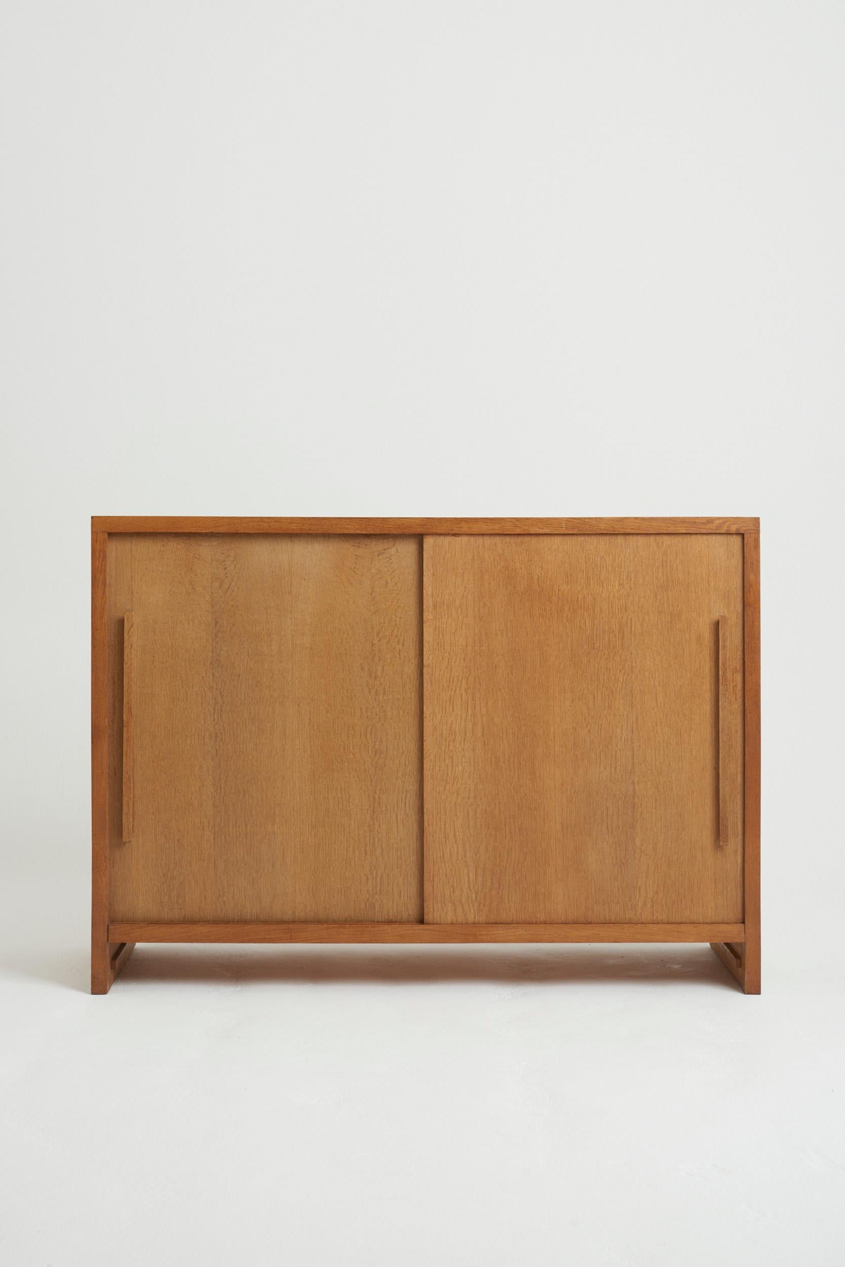 A post-war oak cabinet, with two sliding doors.
France, Circa 1950
100 cm high by 140 cm wide by 50 cm depth