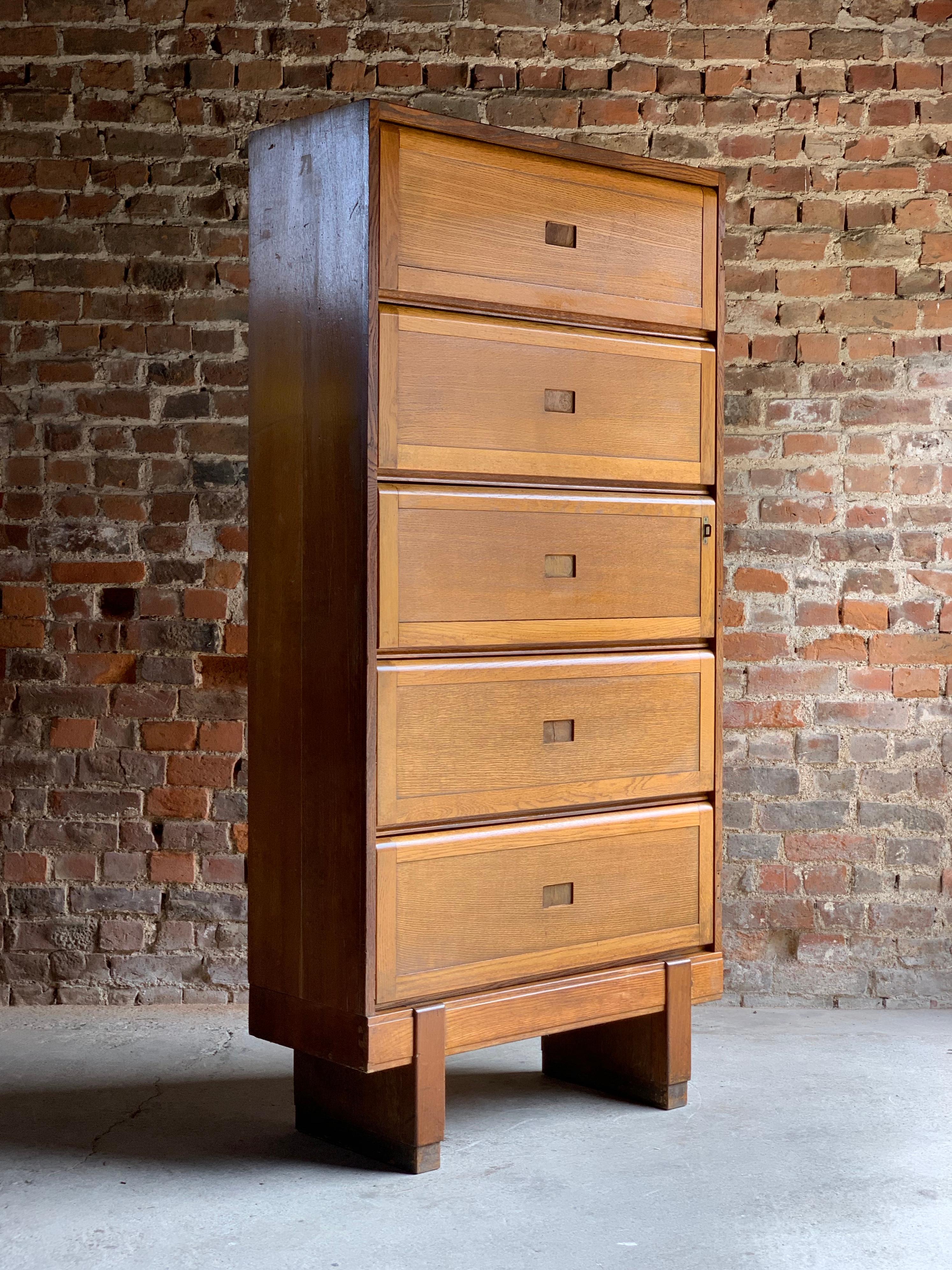 Mid-20th century large oak five shelf cabinet dated 1956, the rectangular top over five up and over sliding action doors, raised on block feet, stamped to the back crowned Government ER Staverton, These units would have been used at RAF Staverton in