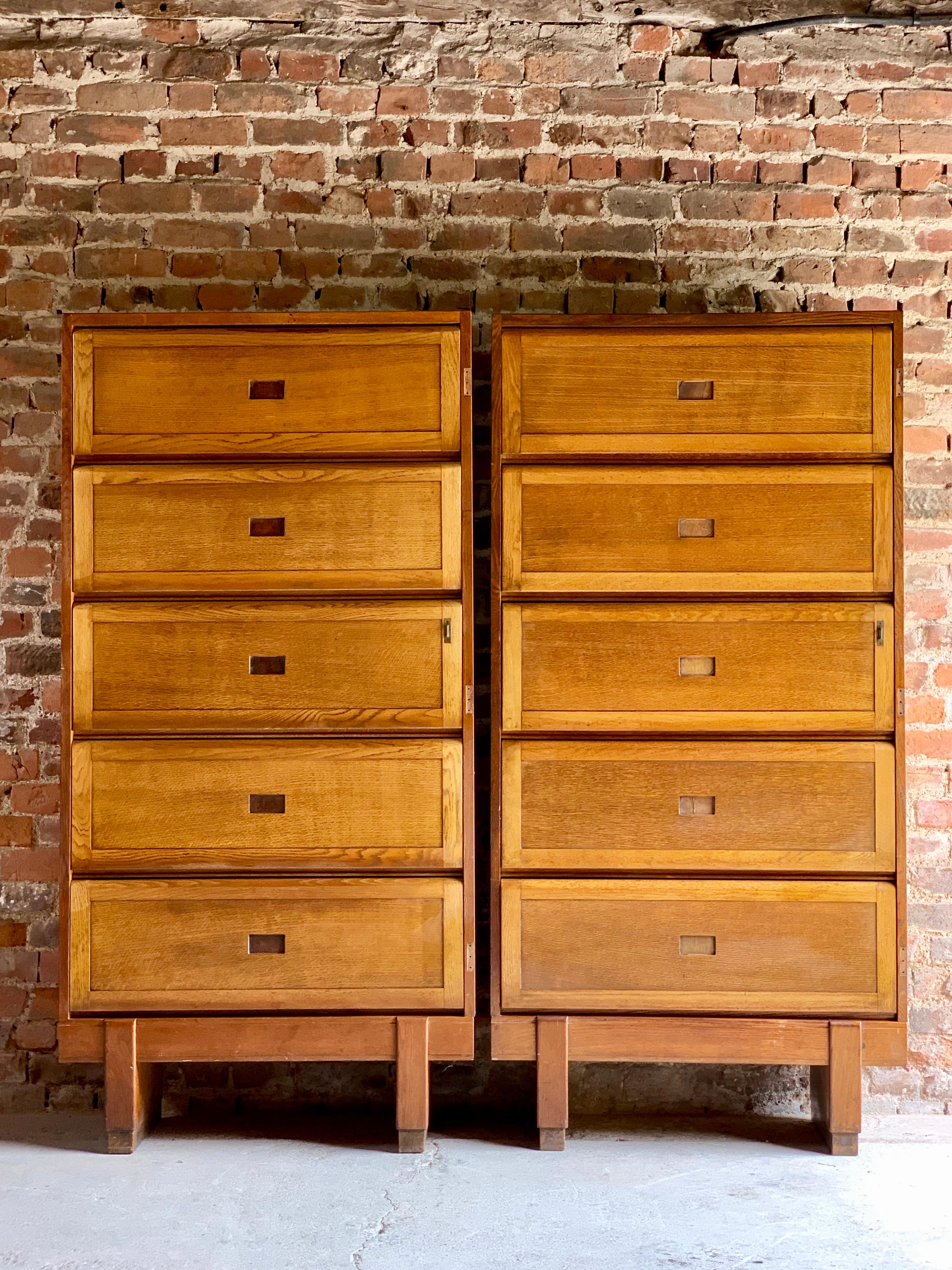 Mid-20th century large oak five shelf cabinet dated 1956, the rectangular top over five up and over sliding action doors, raised on block feet, stamped to the back crowned Government ER Staverton, These units would have been used at RAF Staverton in