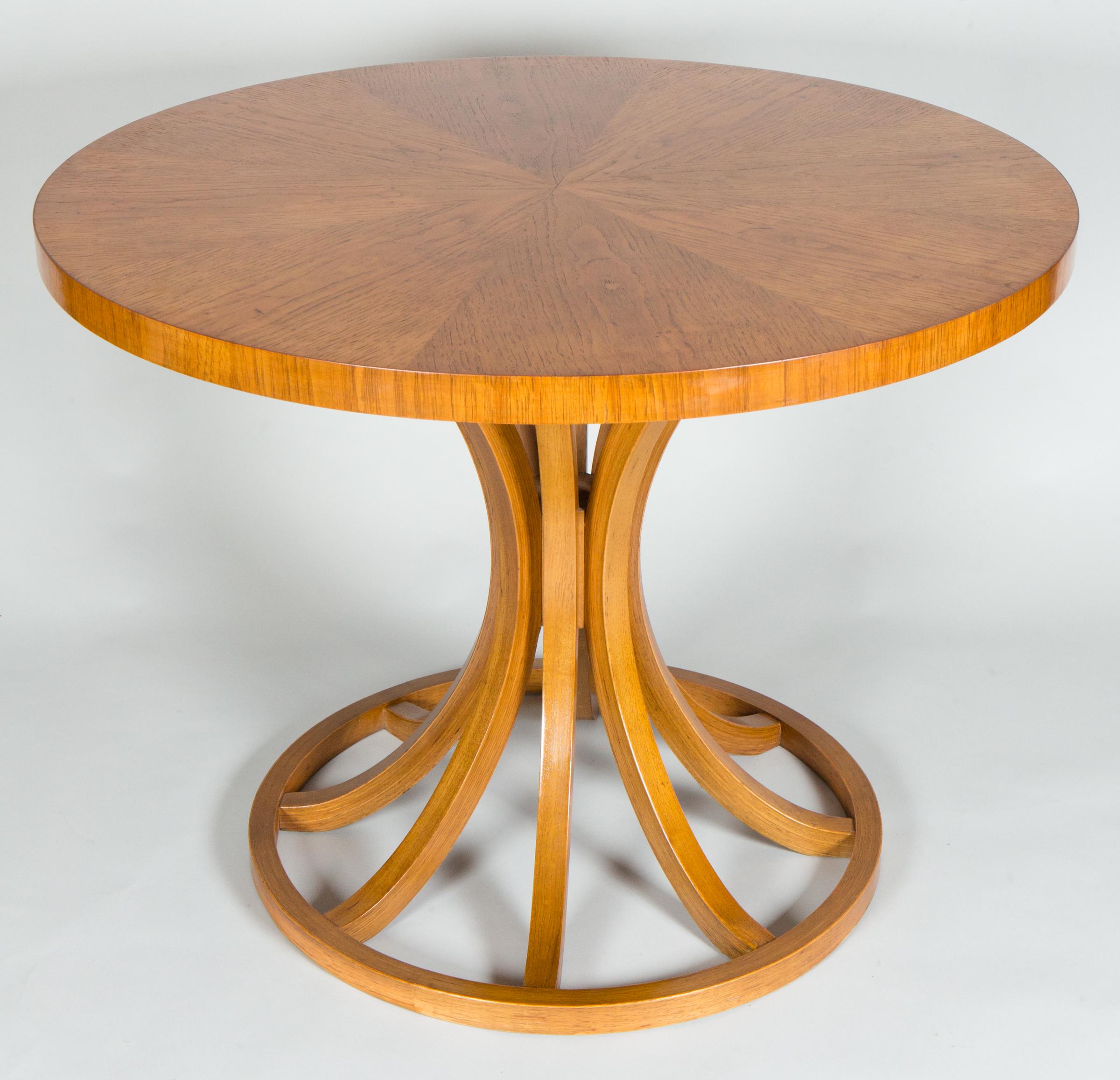 American midcentury oak table with curved legs to give the table a graceful and bold hourglass design.