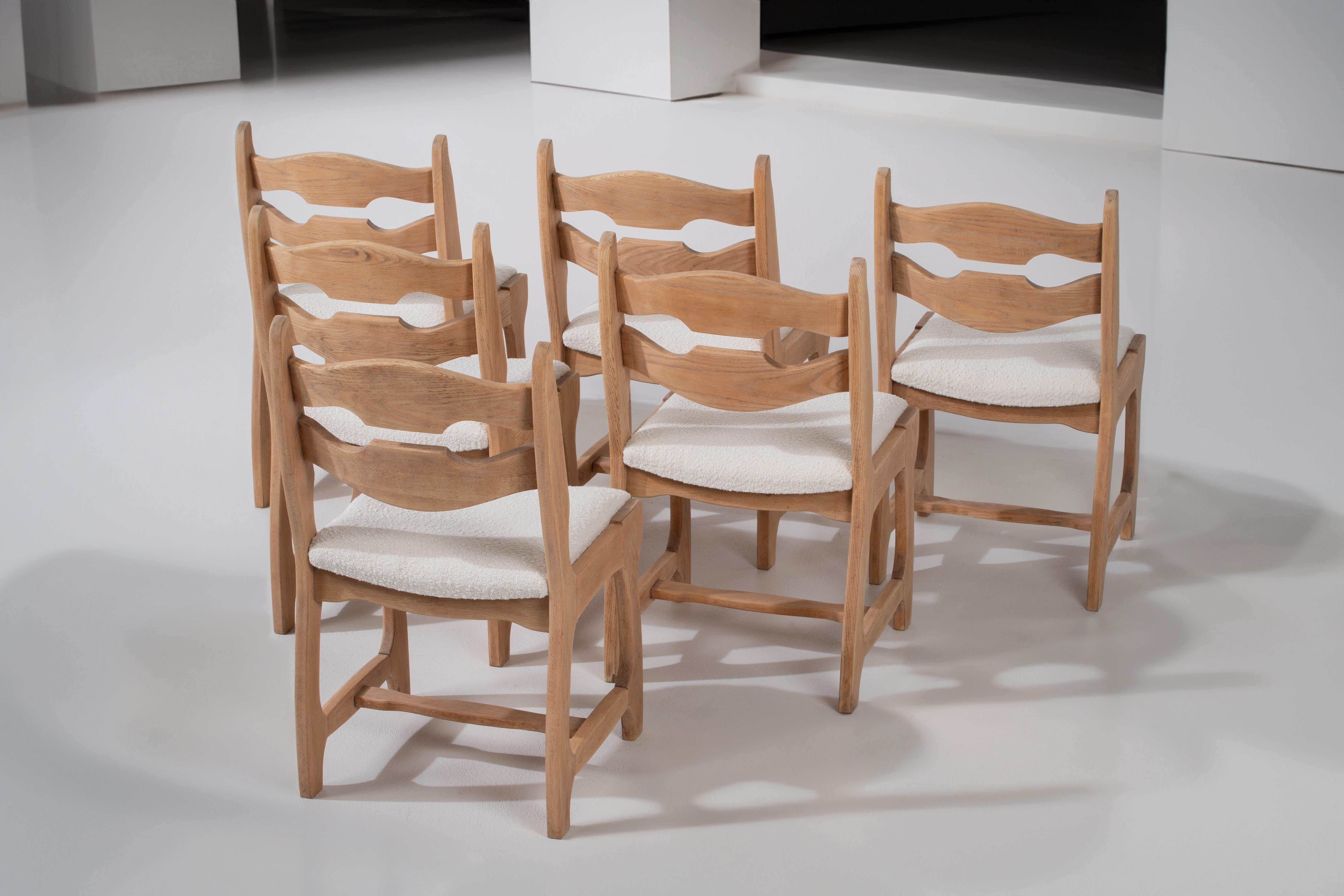 Introducing a stunning set of six oak chairs, designed in the 1960s in the style reminiscent of Henning Kjaernulf and Guillerme and Chambron. These chairs embody a unique combination of elegance and individuality, making them a captivating addition
