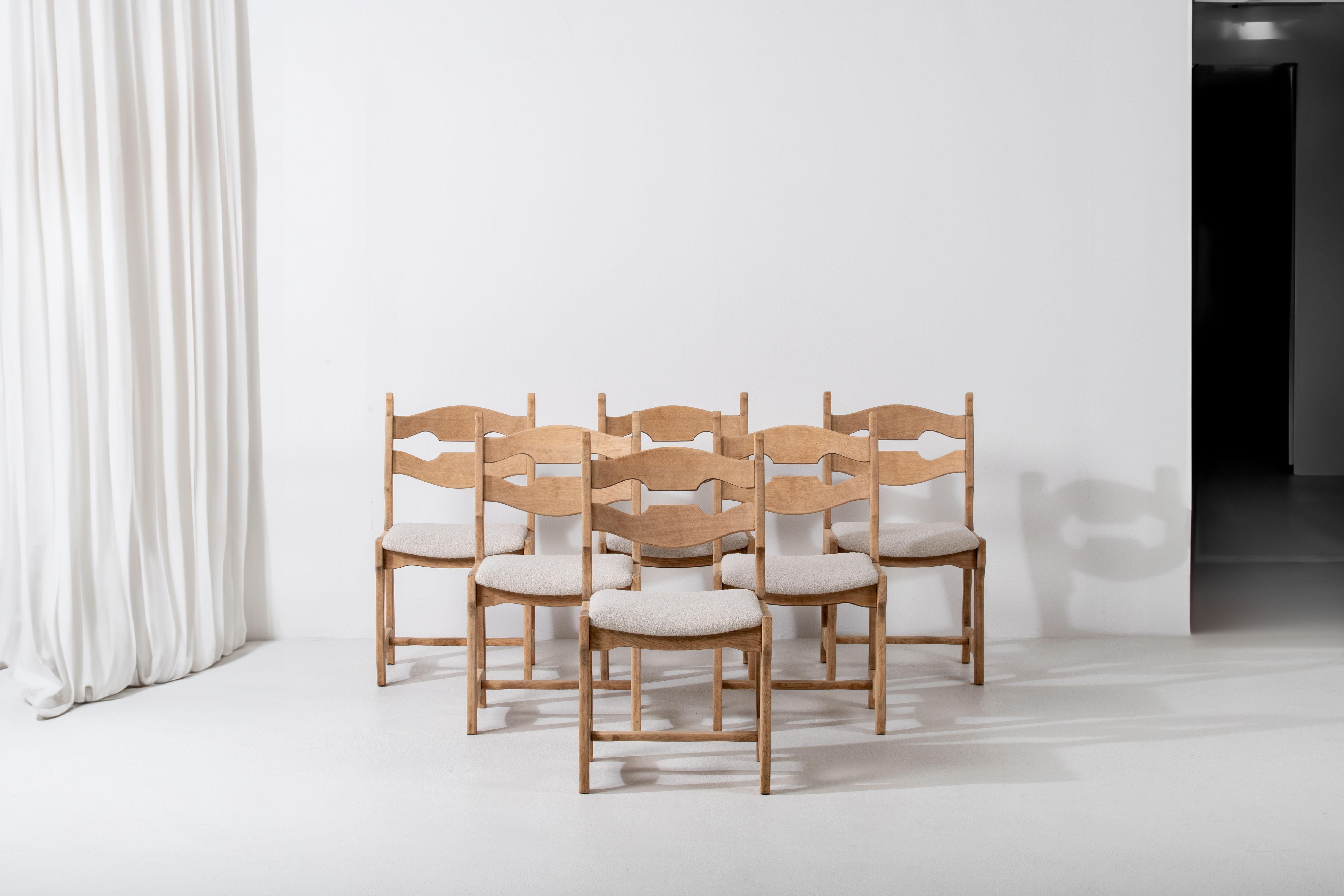 Introducing a stunning set of six oak chairs, designed in the 1960s in the style reminiscent of Henning Kjaernulf and Guillerme and Chambron. These chairs embody a unique combination of elegance and individuality, making them a captivating addition