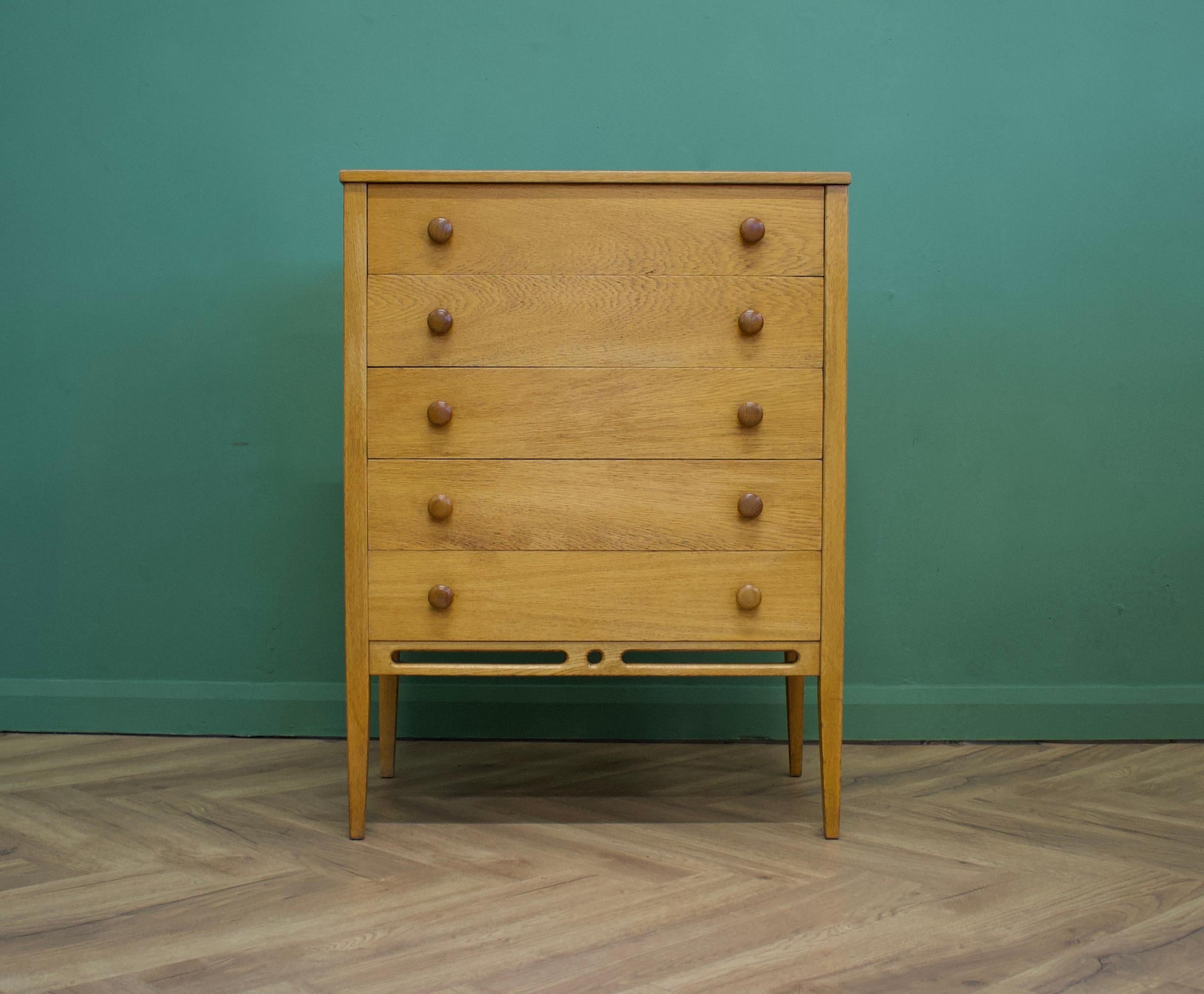 - Midcentury chest of drawers.
- Designed by John Herbert.
- Manufactured in the UK by Younger.
- Made from oak and oak veneer.