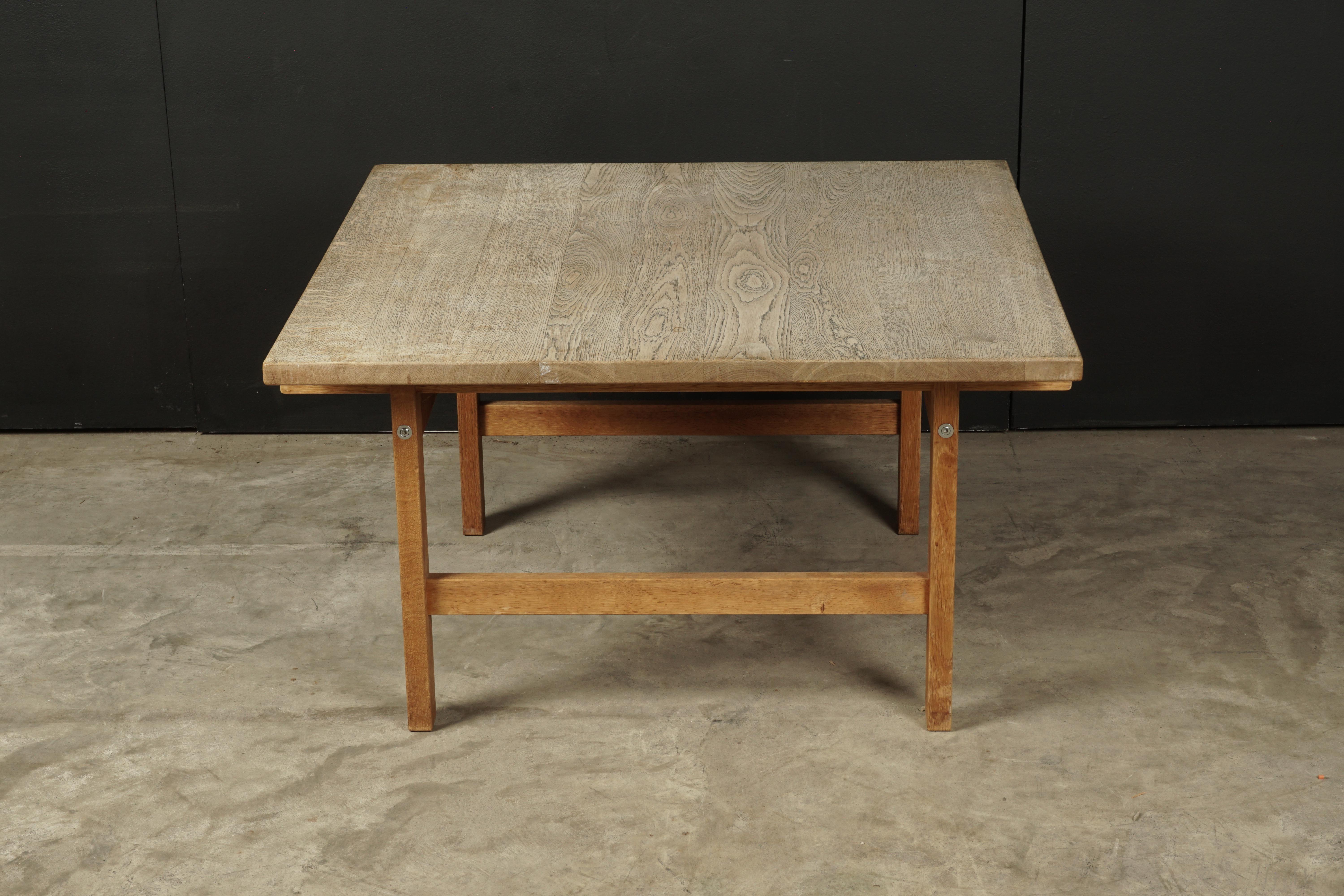 Vintage oak coffee table designed by Hans Wegner, Denmark, circa 1970. Solid oak construction with nice patina and wear. Manufacturer's stamp underneath.