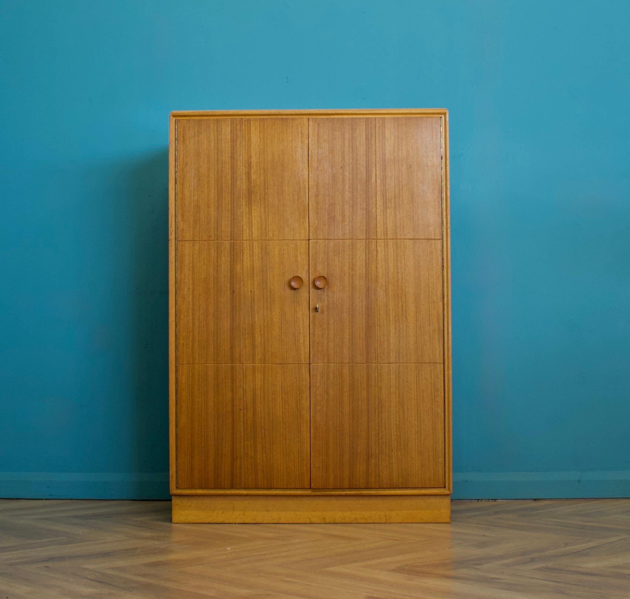 A compactum oak wardrobe from Meredew - circa 1950s
Featuring a pull out hanging rail, shoe rail and shelves


The matching tallboy, wardrobe and dressing table with stool is listed for sale separately