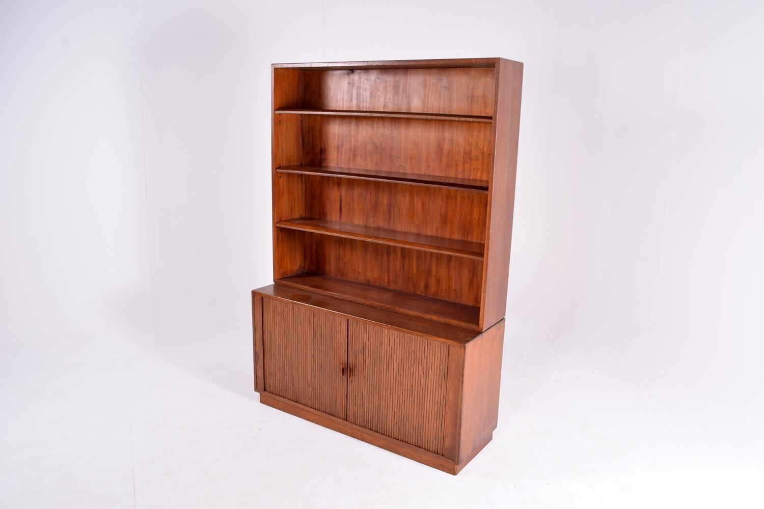 Midcentury Danish oak bookcase, with an amazing woodwork on the bottom part, with two elegant and sliding doors. Adjustable height shelves with on top part, circa 1960.