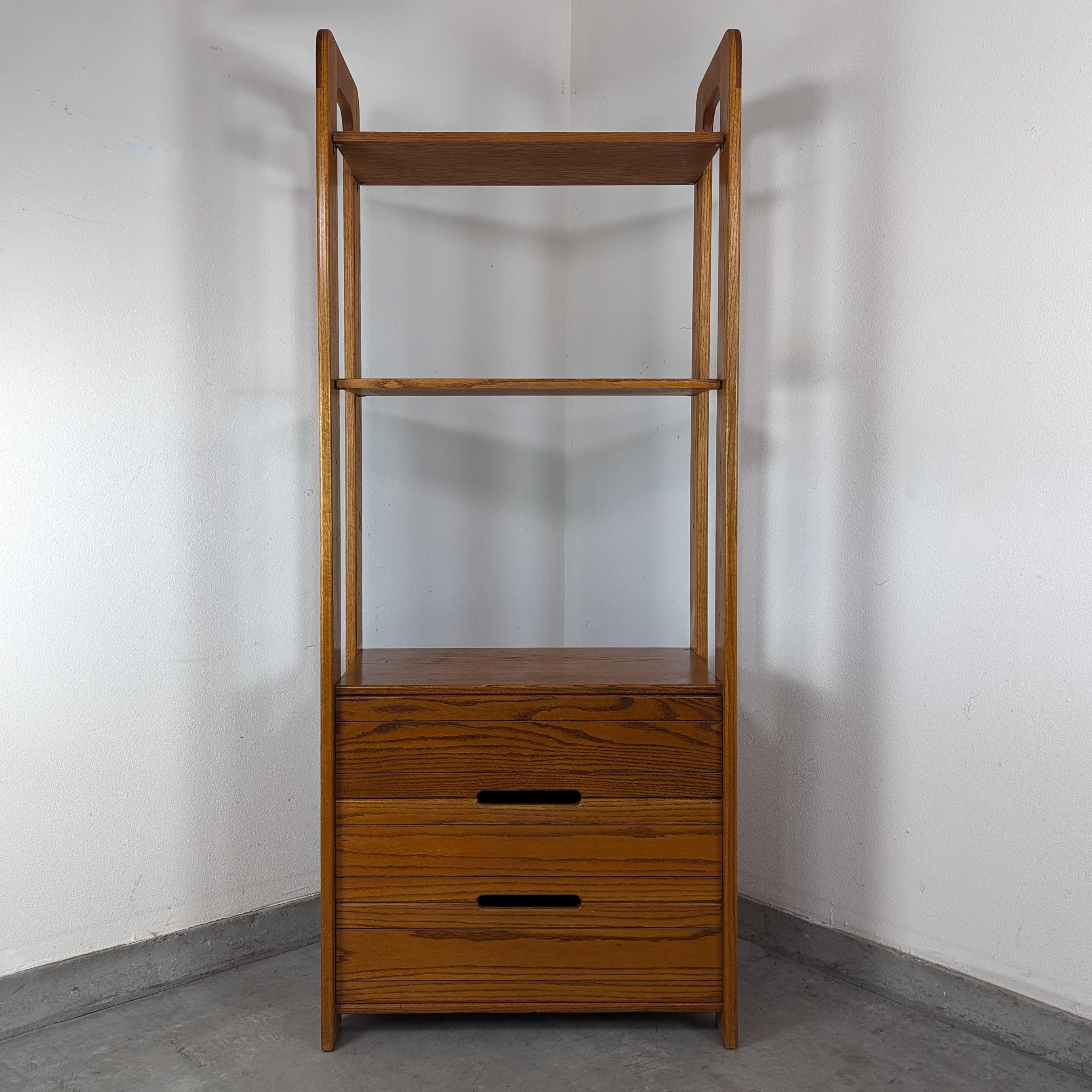 Embrace the timeless elegance and functional design of the mid-century era with this exquisite Freestanding Wall Unit Shelving, masterfully designed by Lou Hodges for the renowned California Design Group in the 1970s. This authentic piece showcases