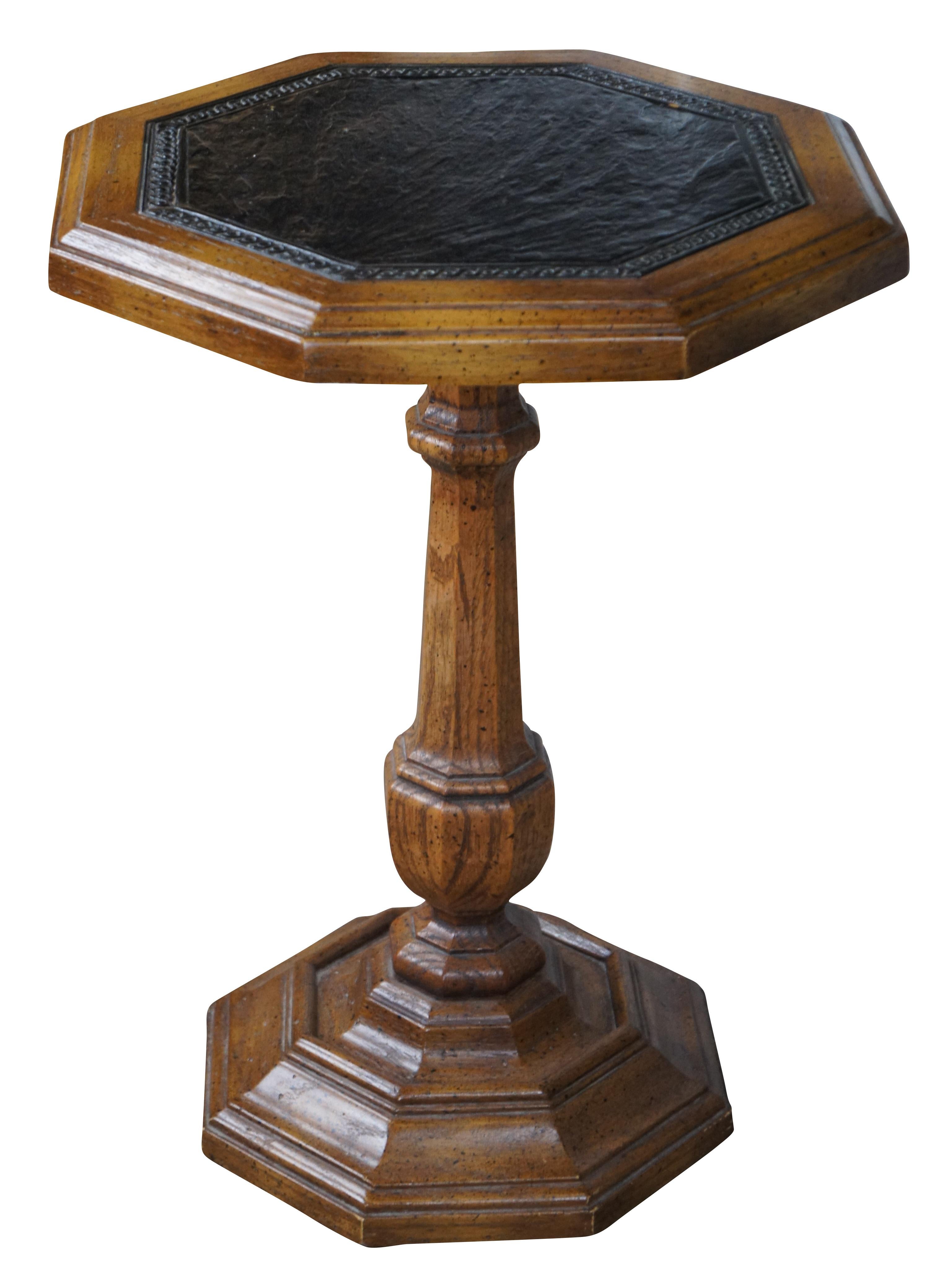 Mid Century oak pedestal or side table.  Features an octangonal form with naturally distressed finsh and leather inset top over a baluster turned column and pedestal base.  Marked Butler along base 562036.  Circa 1960s.

Dimensions:
15