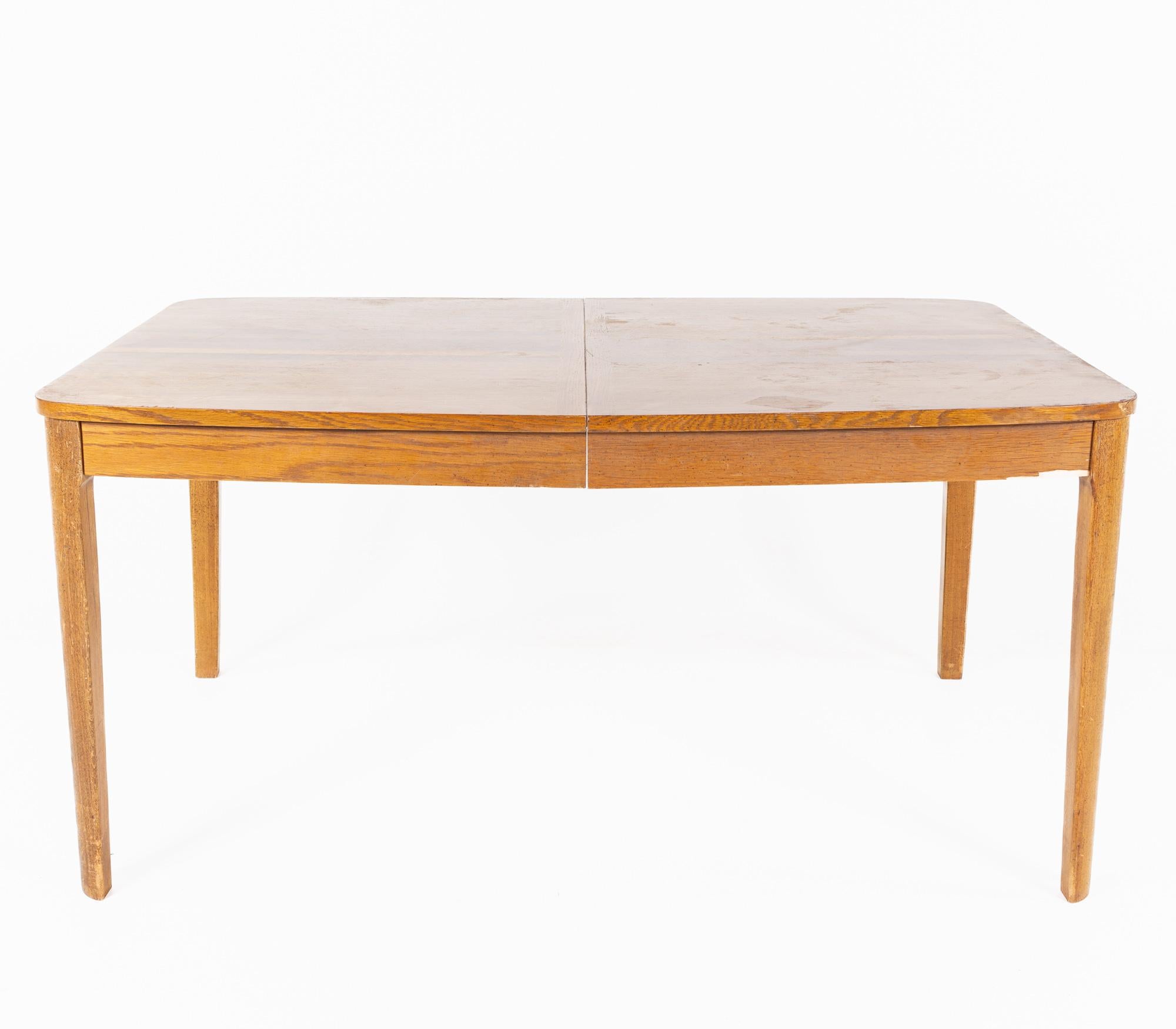 Mid century oak rosewood and walnut expanding dining table

This table measures: 60 wide x 40 deep x 29.5 inches high, with a chair clearance of 25.5 inches, the leaf measures 12 inches wide, making a maximum table width of 72 inches

All pieces