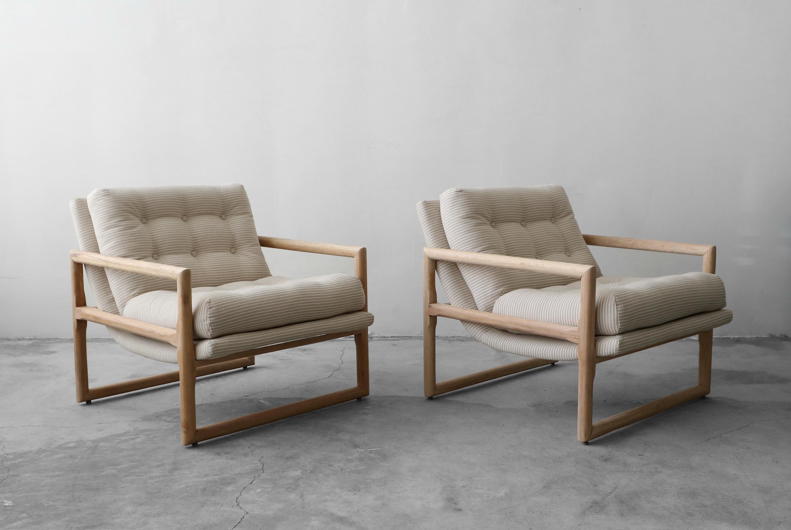 If you're looking for the perfect pair of Minimalist lounge chairs, look no further. This beautiful pair of oak Milo Baughman scoop chairs have been taken out of the 1960s and brought in to 2019. They have all new neutral pinstripe fabric and the