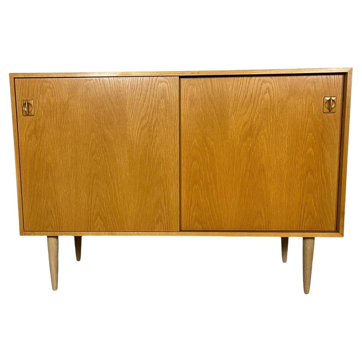 Mid Century Oak Sideboard with Sliding Doors For Sale