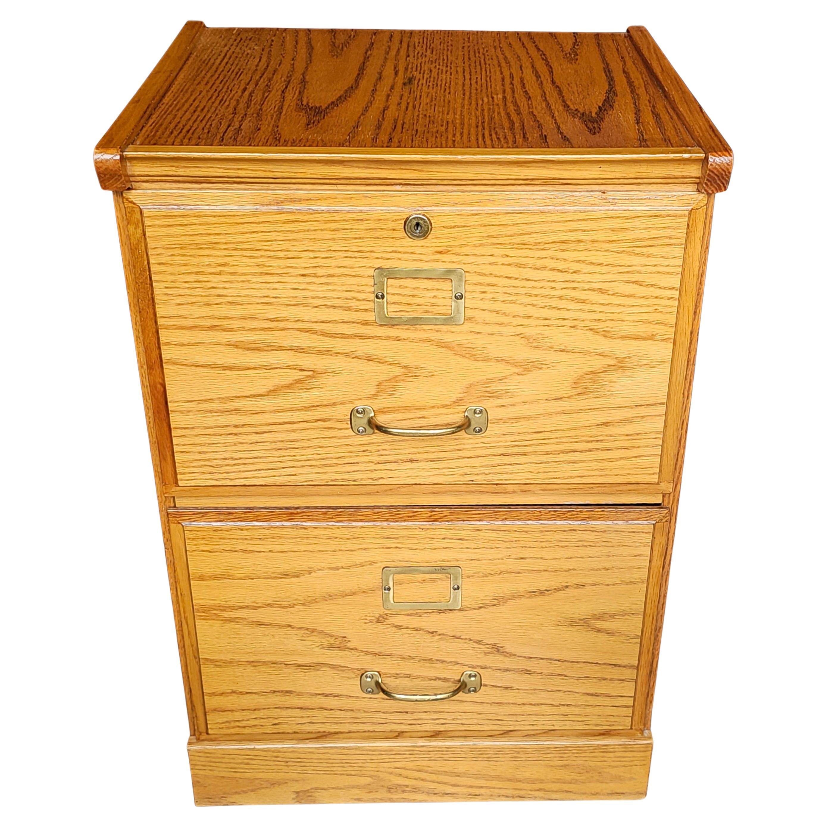 A Mid-Century Oak Two-Drawer Legal Size Filing Cabinet with lock. Will hold legal size and letter size file folders. Come with two keys.
Measures 19