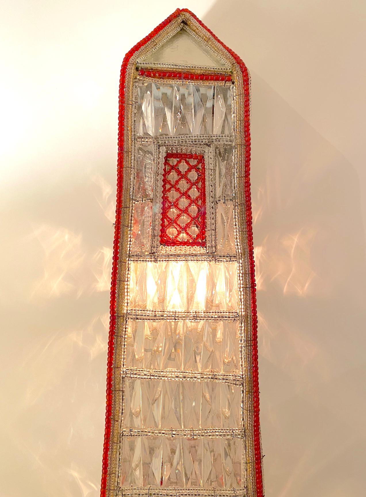  Pair of large, hand-beaded, illuminated, faceted glass and beaded obelisks on mirrored bases. Wired for U.S. current.