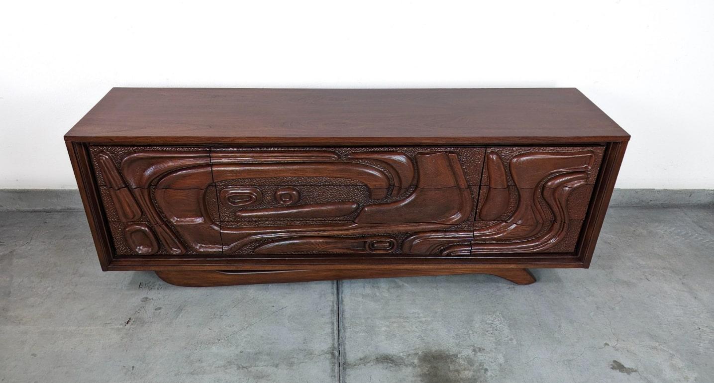 Immerse yourself in the nostalgic allure of the Californian surf culture with this exquisite vintage mid-century 'Oceanic' sculpted walnut dresser by Pulaski Furniture Corporation, dating back to the vibrant 1960s. A treasured relic of the era, this