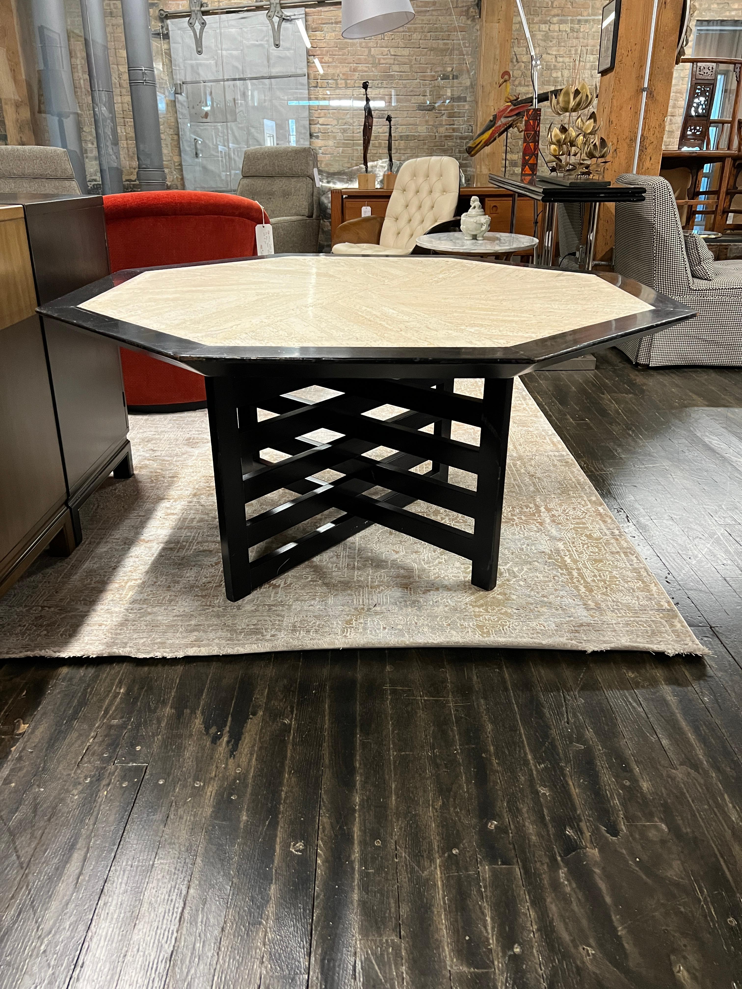 Bold, geometric table designed and manufactured by Harvey Probber. It has a cross-hatch pedestal base and an octagonal top of travertine mosaic outlined by a thick beveled wood framed edge in an ebonized finish.

Although there are no makers marks,