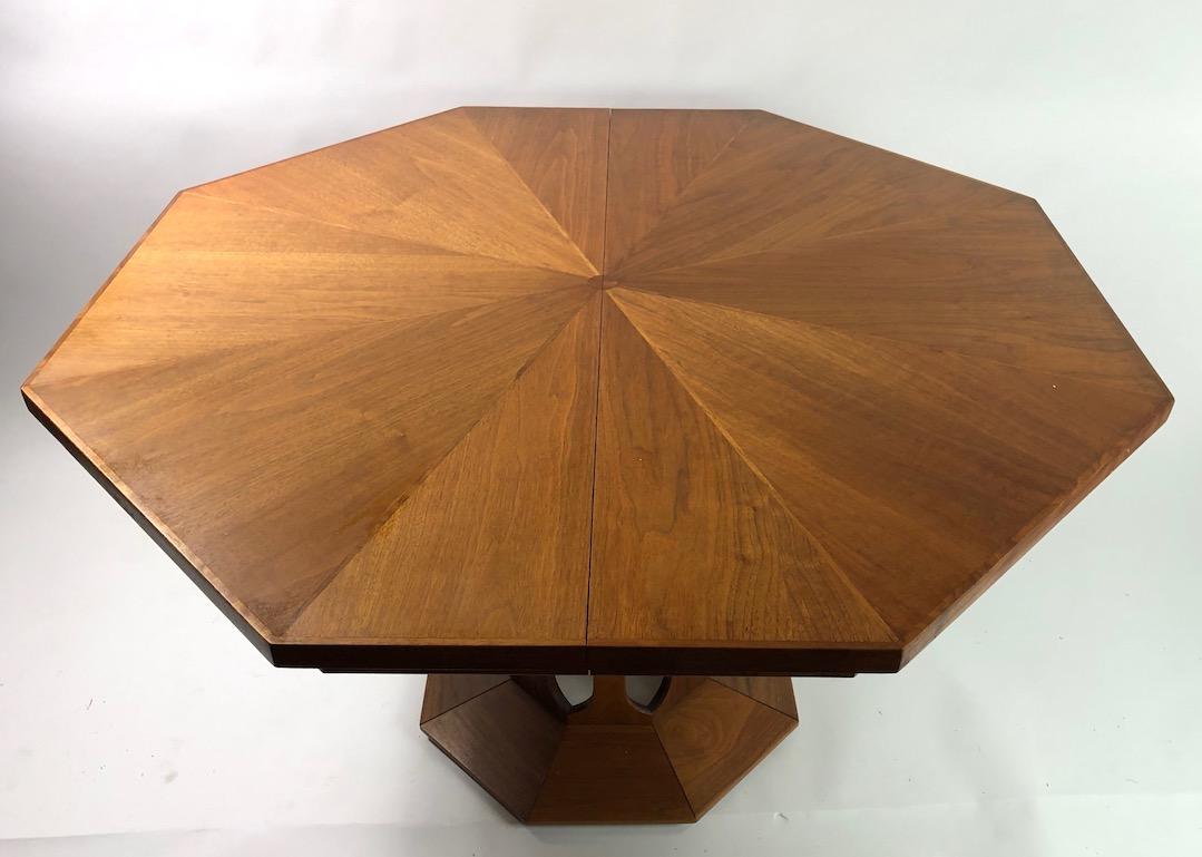 Exceptional dining table with inlay top, and three large leaves (15.75 inch each). The table features an open work pedestal base which supports a large octagonal top, each facet measures 20 inch x total W 48 inch x 52 inch Diameter. With all three