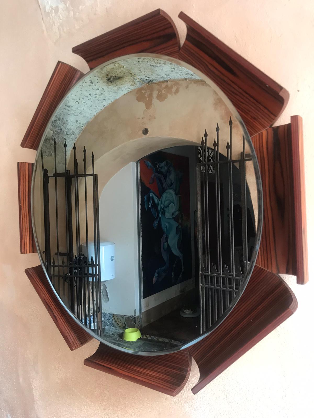 An incredibly unique midcentury italian octagonal -shaped solid bentwood wall-mounted mirror. Eight folded curves inward toward the mirror surface. circa 1950s. The mirror has bevelled edges. The glass mirror is cm 50 diameter

In excellent vintage