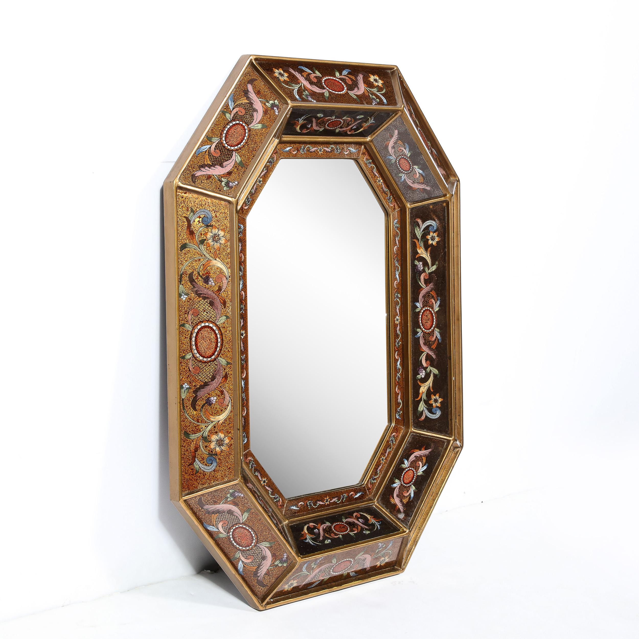 This stunning mid century octagonal shadowbox mirror was realized in Italy, circa 1950.. It features three layers composed of a wealth of handpainted panels diminishing in thickness as they move towards the interior octagonal plain mirror panel. The
