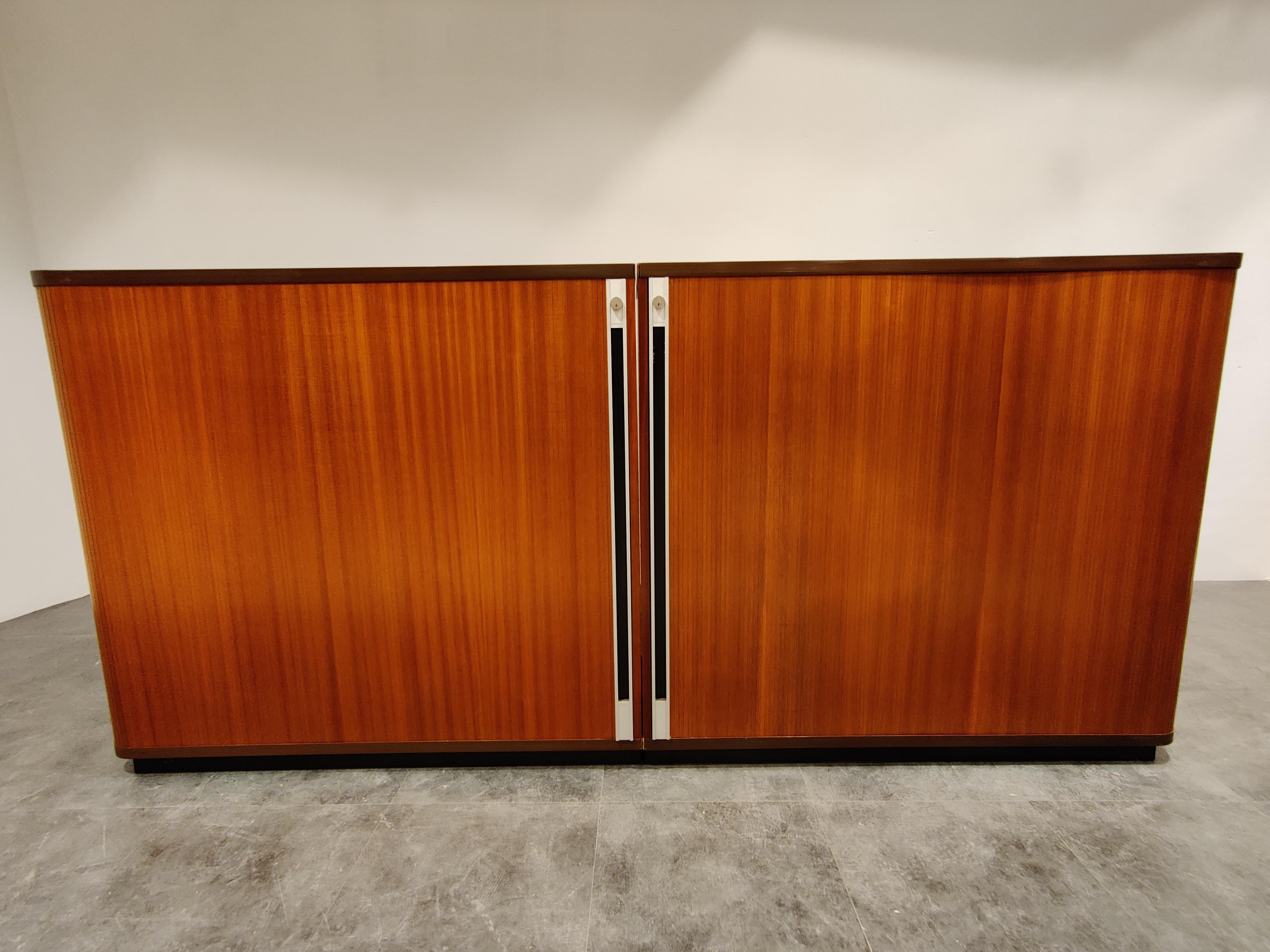 Double midcentury office cabinet with tambour doors and adjustable shelves made in Belgium.

This very practical cabinet offers a lot of storage space and adds a lovely vintage touch to you office.

Good height and large doors.

Timeless