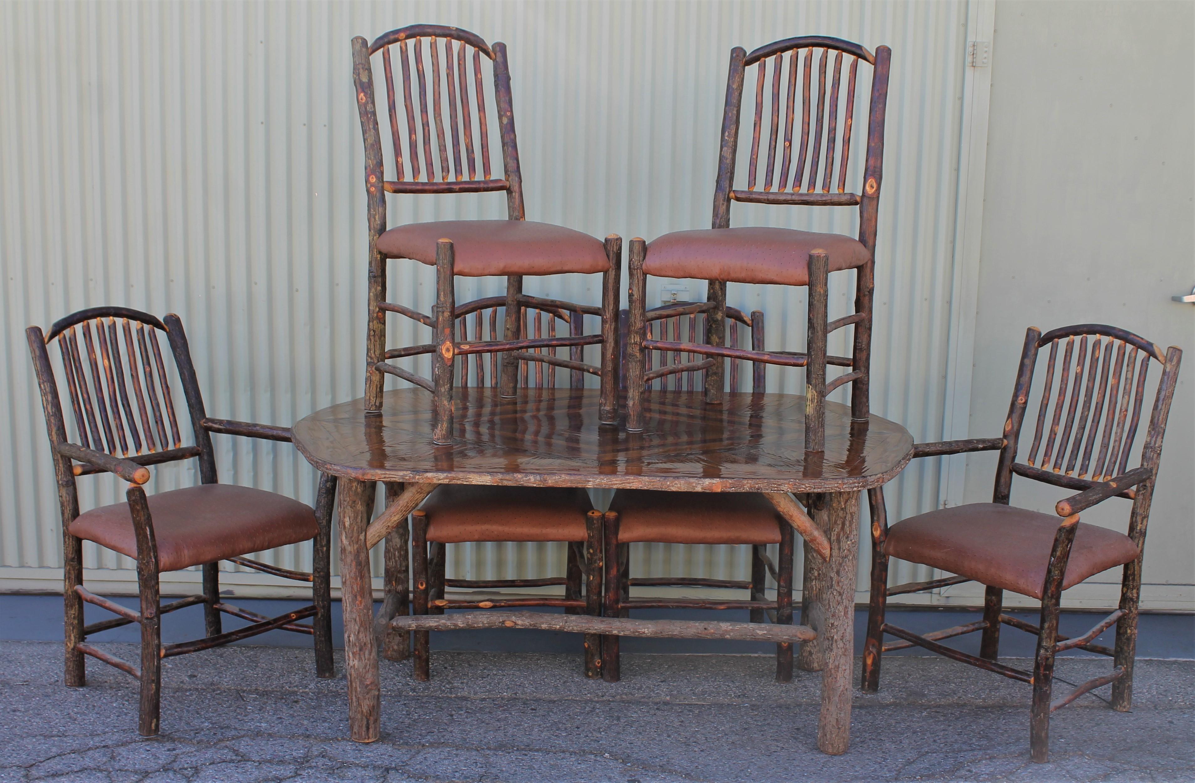 This amazing seven pieces matching chairs and oval table signed Old Hickory. All in very good condition. The tabletop is a marque inlaid top.

Measures: Armchairs 41 x 28 x 28 only on arm chair in stock.

Side chairs 41 x 19 x 19 
Seat height for