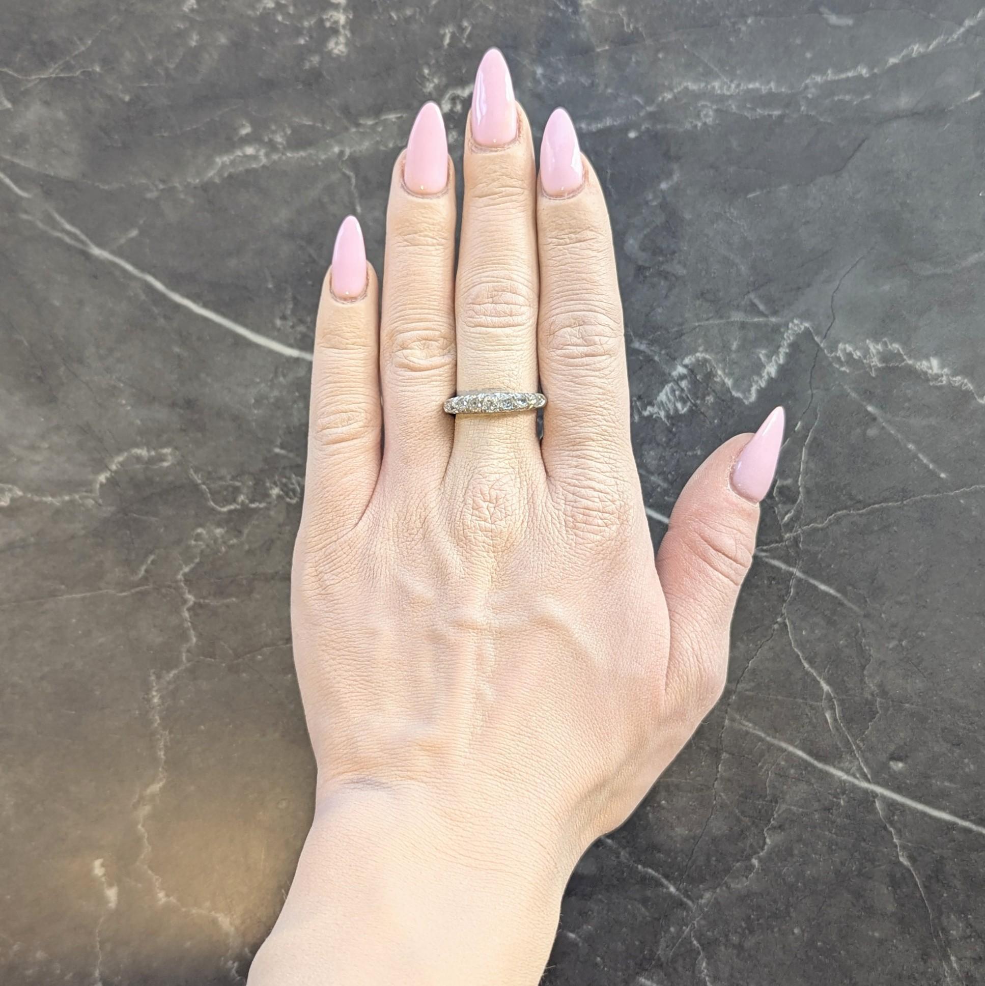 Centering seven graduated old mine cut diamonds prong set eats to west
Weighing approximately 0.60 carat total - I to K color with SI1 clarity
Featuring a pierced fishtail style profile
Flanked by rounded shoulders
Partially inscribed
Tested as 14