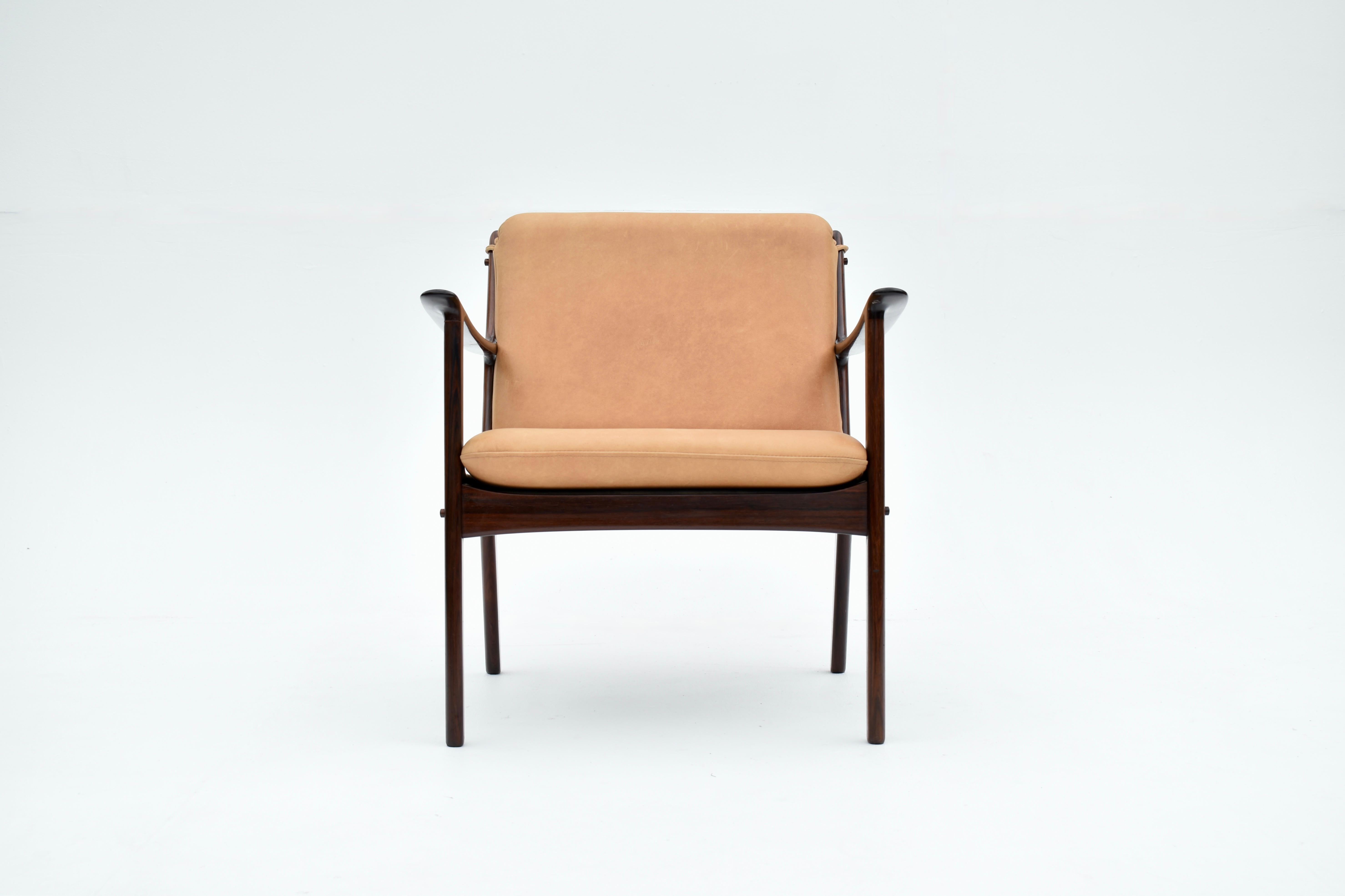 Elegant lounge chair crafted from solid Brazilian Rosewood, designed by professor Ole Wanscher in the mid 50’s for Poul Jeppesen.

The design references classical forms while adhering to the very best traditions of Danish Modern.  A simple