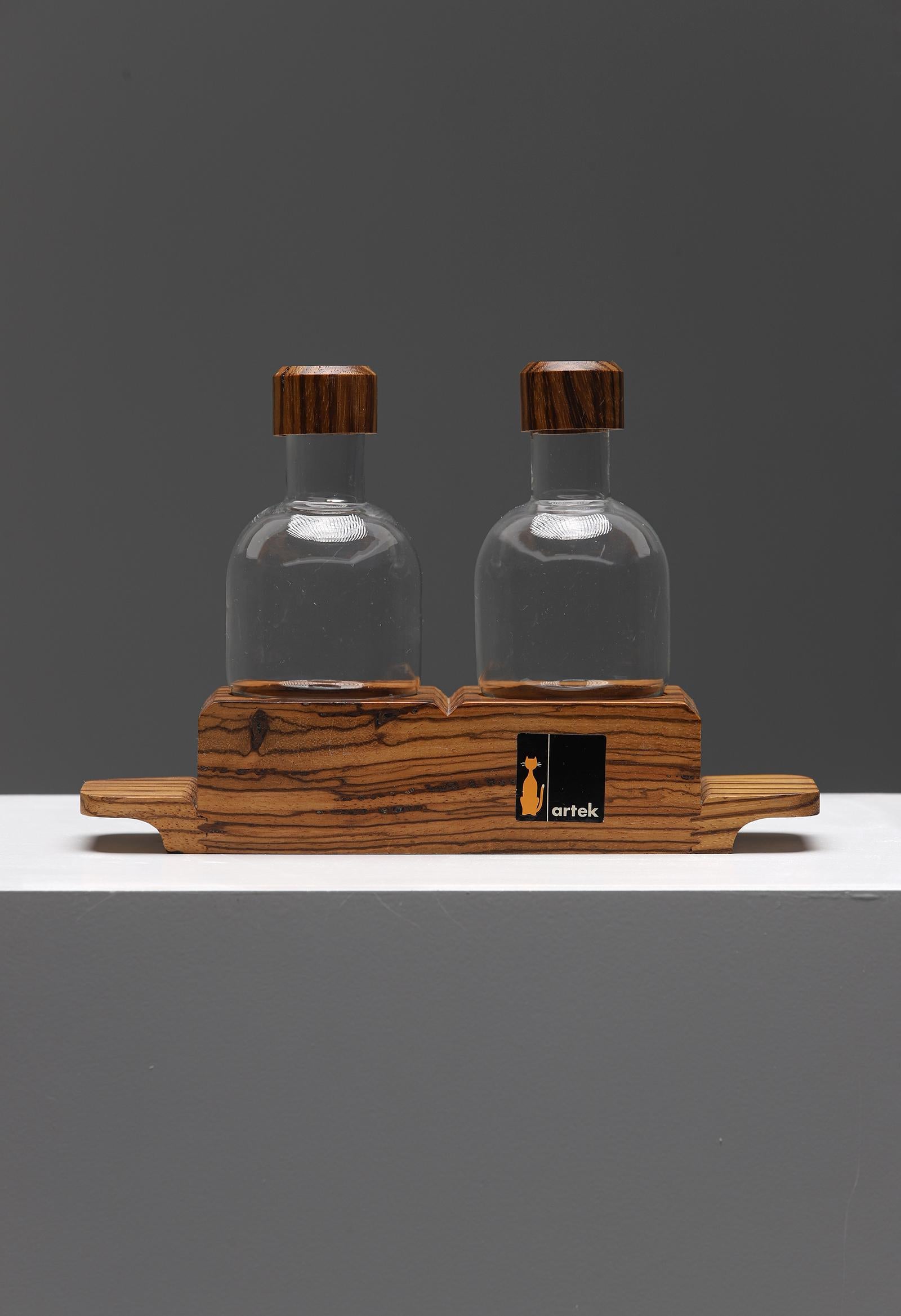 Mid Century olive oil and vinegar set designed and produced by Artek in the 1960s. Artek was founded in Helsinki in 1935 by four young idealists: Alvar and Aino Aalto, Maire Gullichsen and Nils-Gustav Hahl. They wanted to promote a modern culture of