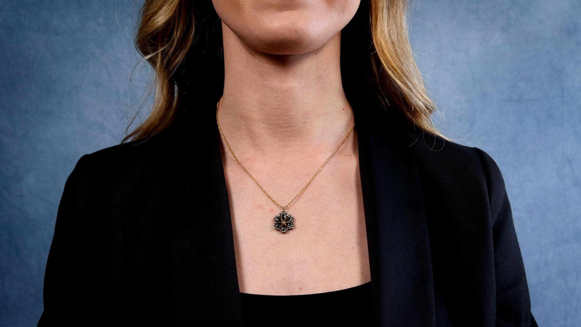 One Mid-Century Onyx and Diamond 14k Yellow Gold Silver Pendant Necklace. Featuring six pear cut onyx. Accented by 30 single cut diamonds with a total weight of approximately 0.30 carat, graded near-colorless to faint, SI-I1 clarity. Crafted in a 14