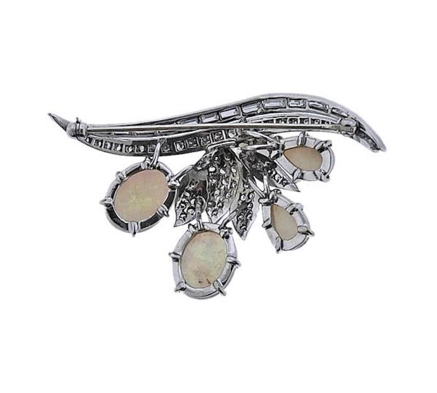 This gorgeous mid-century retro opal brooch is extremely high quality set with 0.85 carats of lovely brilliant cut and baguette diamonds 

This piece makes a stunning clip to a dress but can also be used as an amazing  necklace pendant. It is set