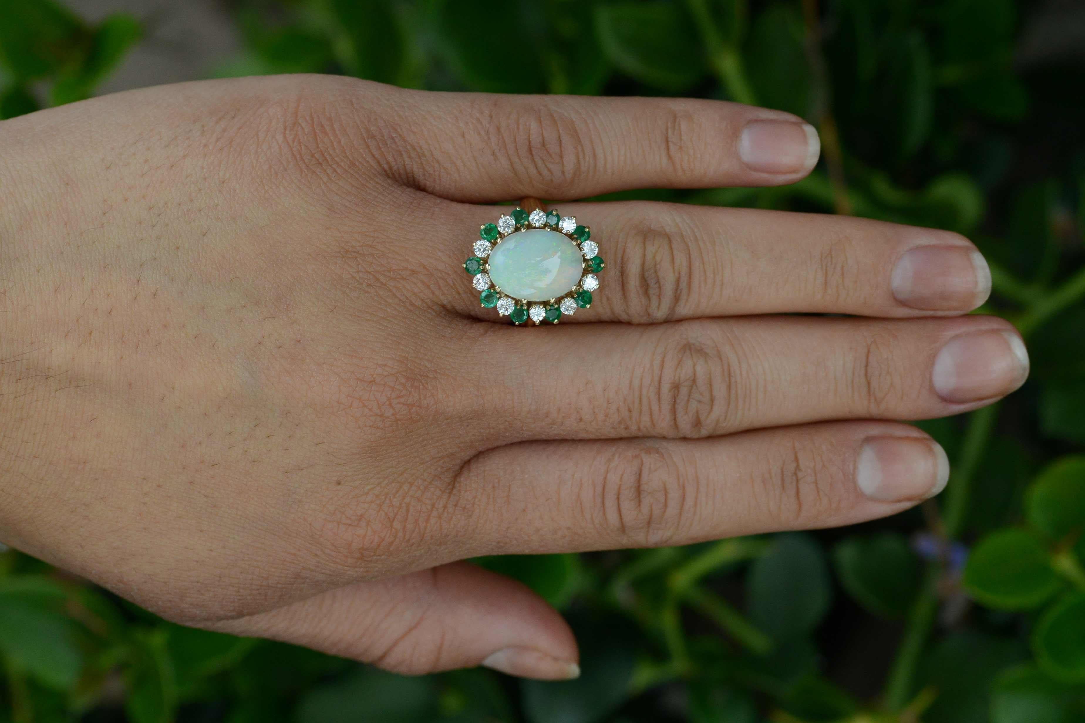 A swoon-worthy Mid Century dome cocktail ring with a dynamic, gorgeous, fiery pinfire opal at it's heart. The sizable 4 Carat gemstone glows with an inner fire, having a dynamic play-of-color, emitting rolling flashes of greens, yellows, pinks and