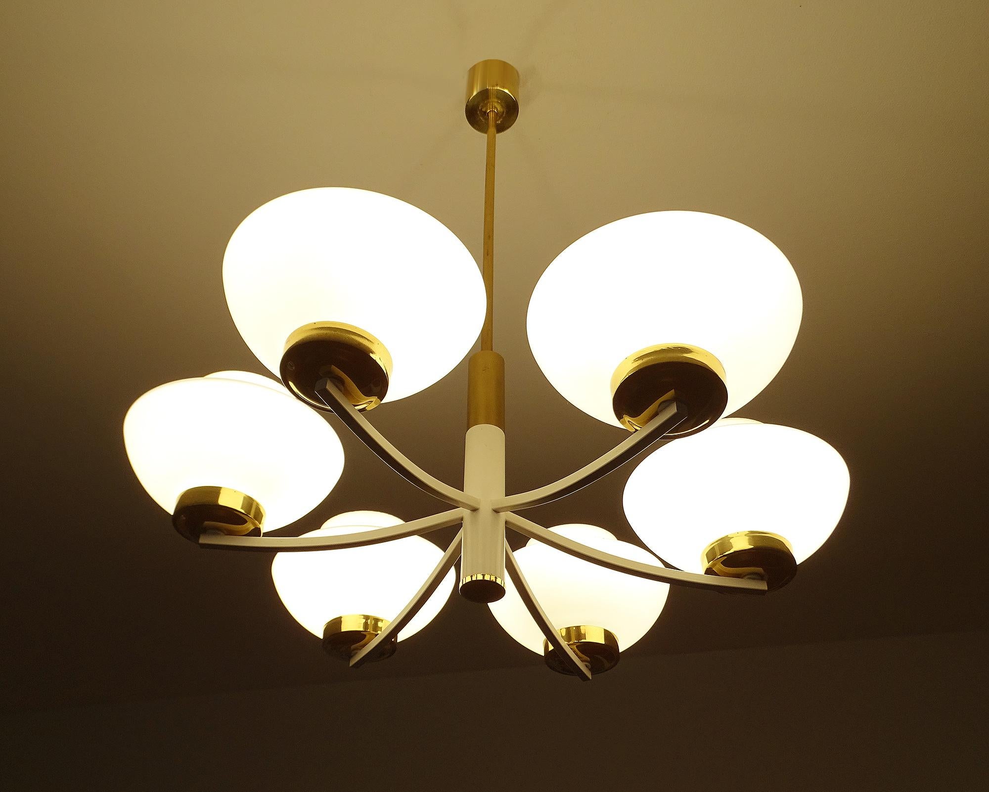 1960s midcentury chandelier in the manner of Stilnovo, white enameled arms with brass trim, flattened amphora shape opaline glass shades.
Wiring: The lamps have been tested with US American light bulbs under 120v and they work flawlessly. 