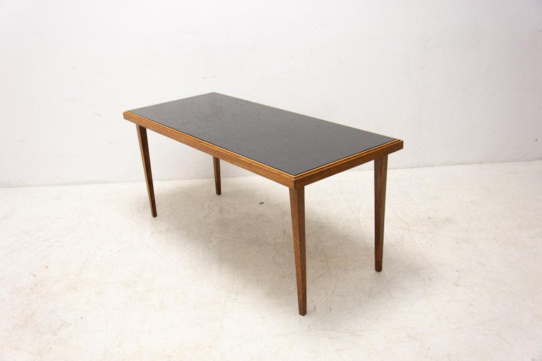 Mid century opaxite glass coffee table from the 1960´s.

It has a beechwood structure and black glass tabletop. In good Vintage condition, showing signs of age and using (a few scratches on the wood)

Height 59 cm,

length 130 cm

width 55 cm