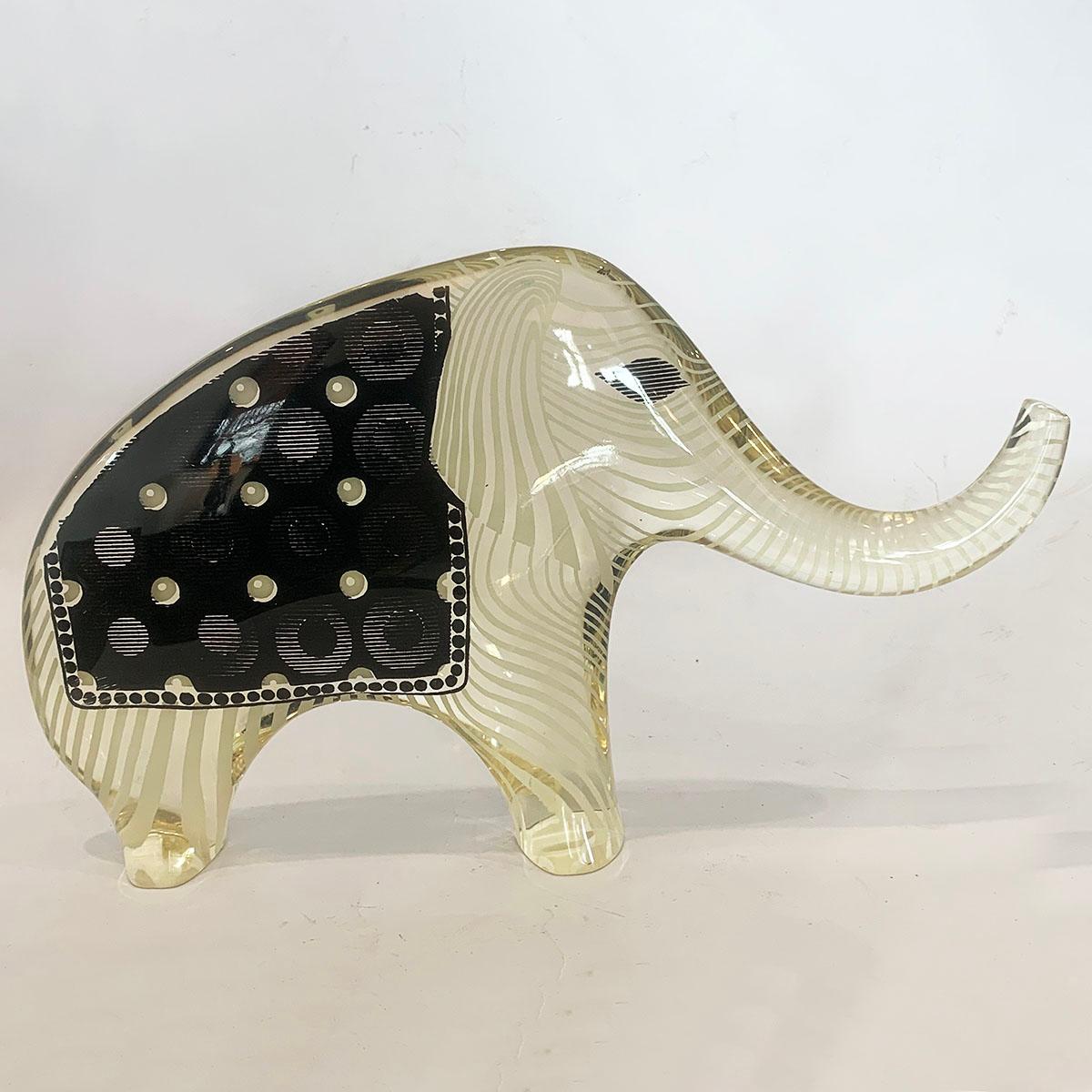 Midcentury optical illusion elephant in “Salute” stance, wearing patterned blanket, large size. In clear optic Lucite by Abraham Palatnik, Brazil, a world famous design by this great Artist. The clear French Lucite is curve moulded in 2 halves with