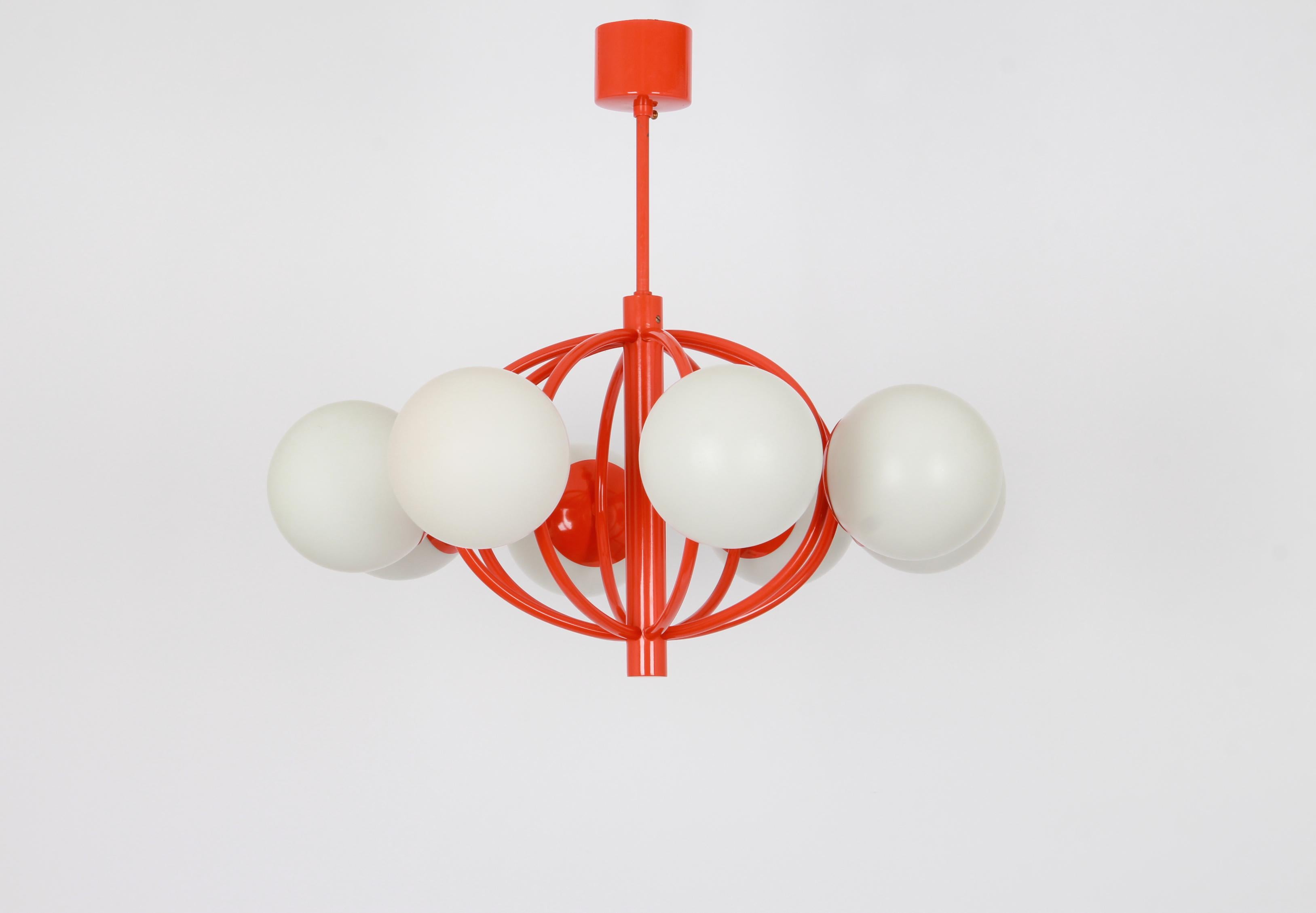 Midcentury vintage pendant in orange color made by Kaiser Leuchten, Germany with 8 opal glass balls.
High quality and in very good condition. Cleaned, well-wired and ready to use. 

The fixture requires 8 x E14 small bulbs with 40W max