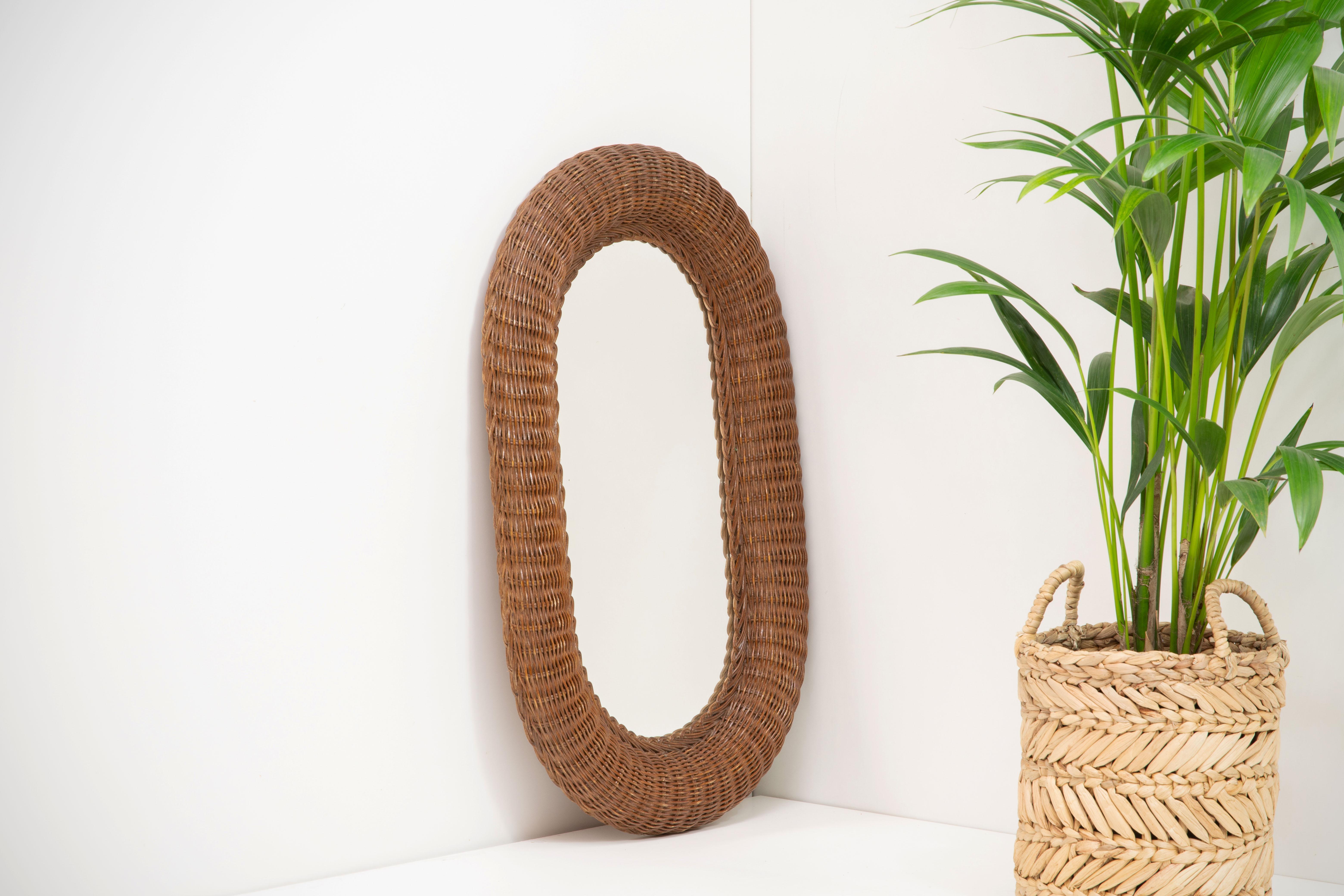 Oval French Organic Artisanal Rattan / Wicker mirror from the 1960s. Intricate design with various weaving patterns as well as wooden beads incorporated into the frame. Original mirror with minor wear. French Riviera

Other designers of the period
