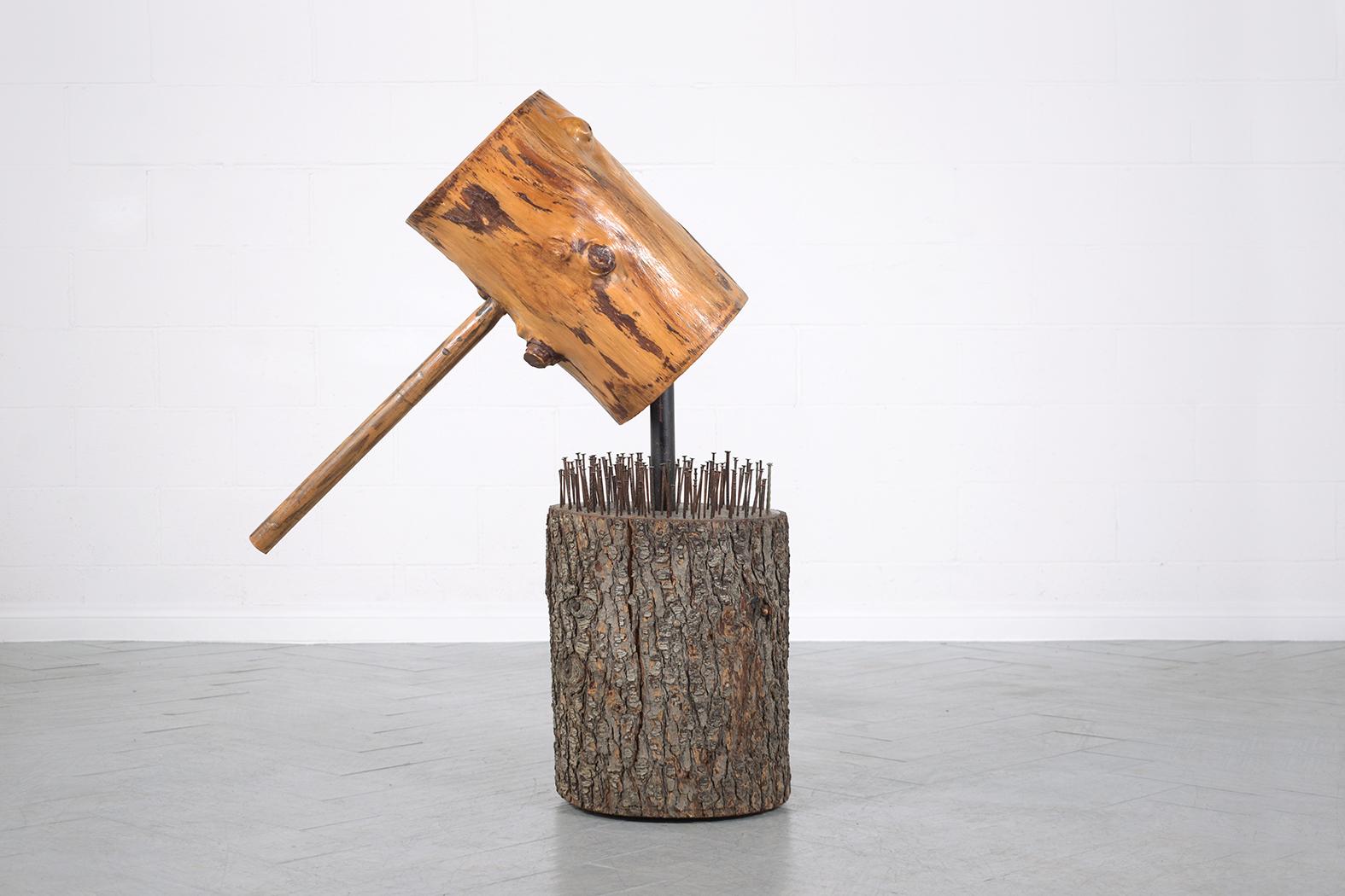 Discover our extraordinary 1950s organic modern sculpture, meticulously crafted from wood and in good condition, ready to enhance your space for years to come. This eye-catching piece features a floating hammer, stained in a natural color, waxed,