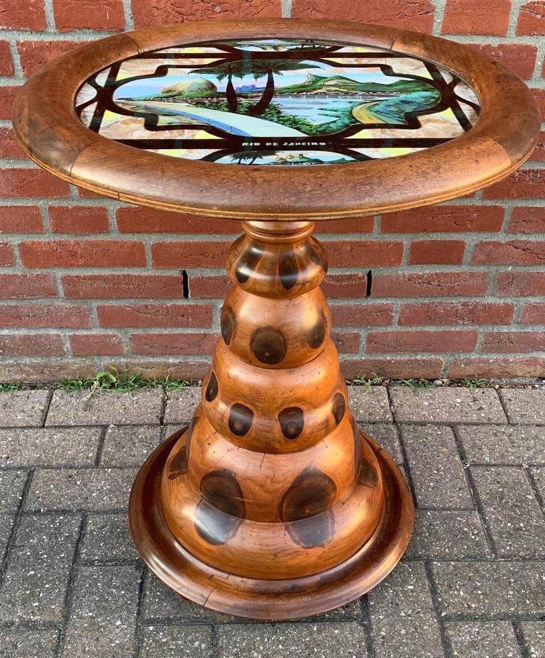 Exotic wooden table with hand painted and colorful Rio de Janeiro landmark(s).

From the same eclectic interior as the matching table lamp that we sold a few weeks ago, we also purchased this rare and marvelous table. This mushroom shape table has