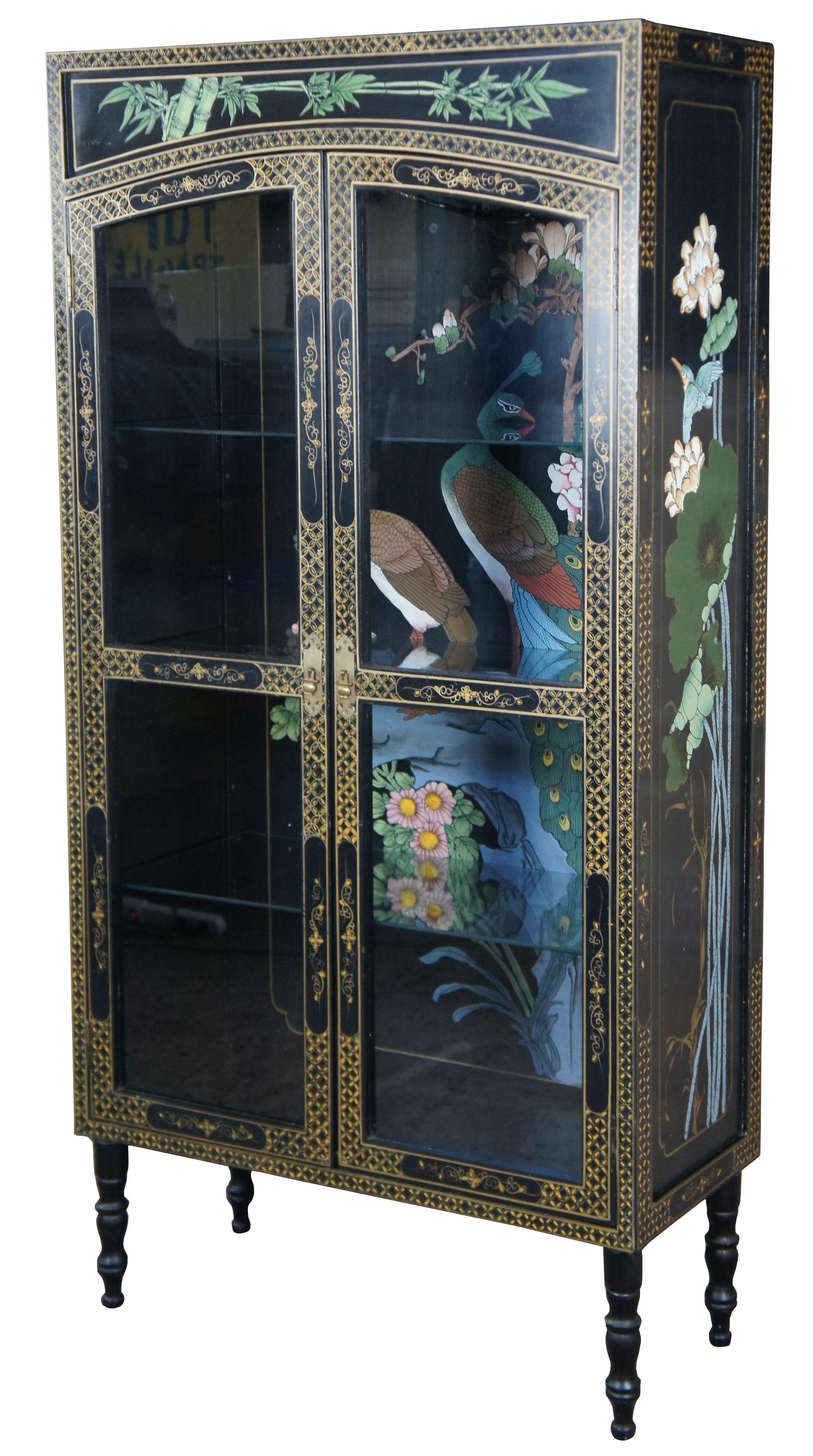 Mid century Oriental illuminating curio display cabinet featuring black lacquer finish with gold accents and two Peacocks nesting in a flowering tree with hummingbirds / birds. Measure: 63