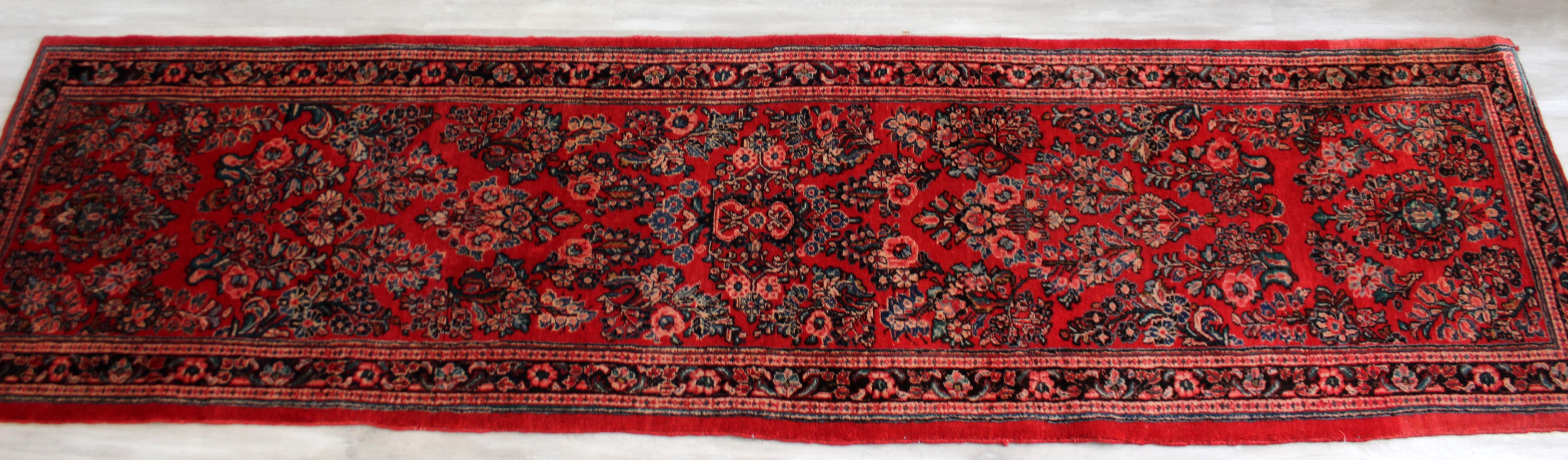 For your consideration is a beautiful and long, hand knotted wool runner rug, handmade. In very good vintage condition. The dimensions are 32.5