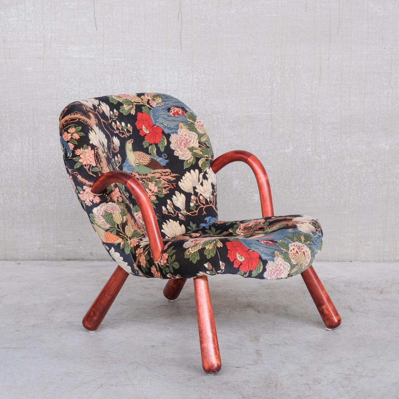 An increasingly hard to find 'clam' chair. 

Denmark, c1950s. 

Attributed to Arnold Madsen, similar models were made by Philip Arctander. 

The current fabric is in good condition but is fairly bright and flamboyant, and is ripe for
