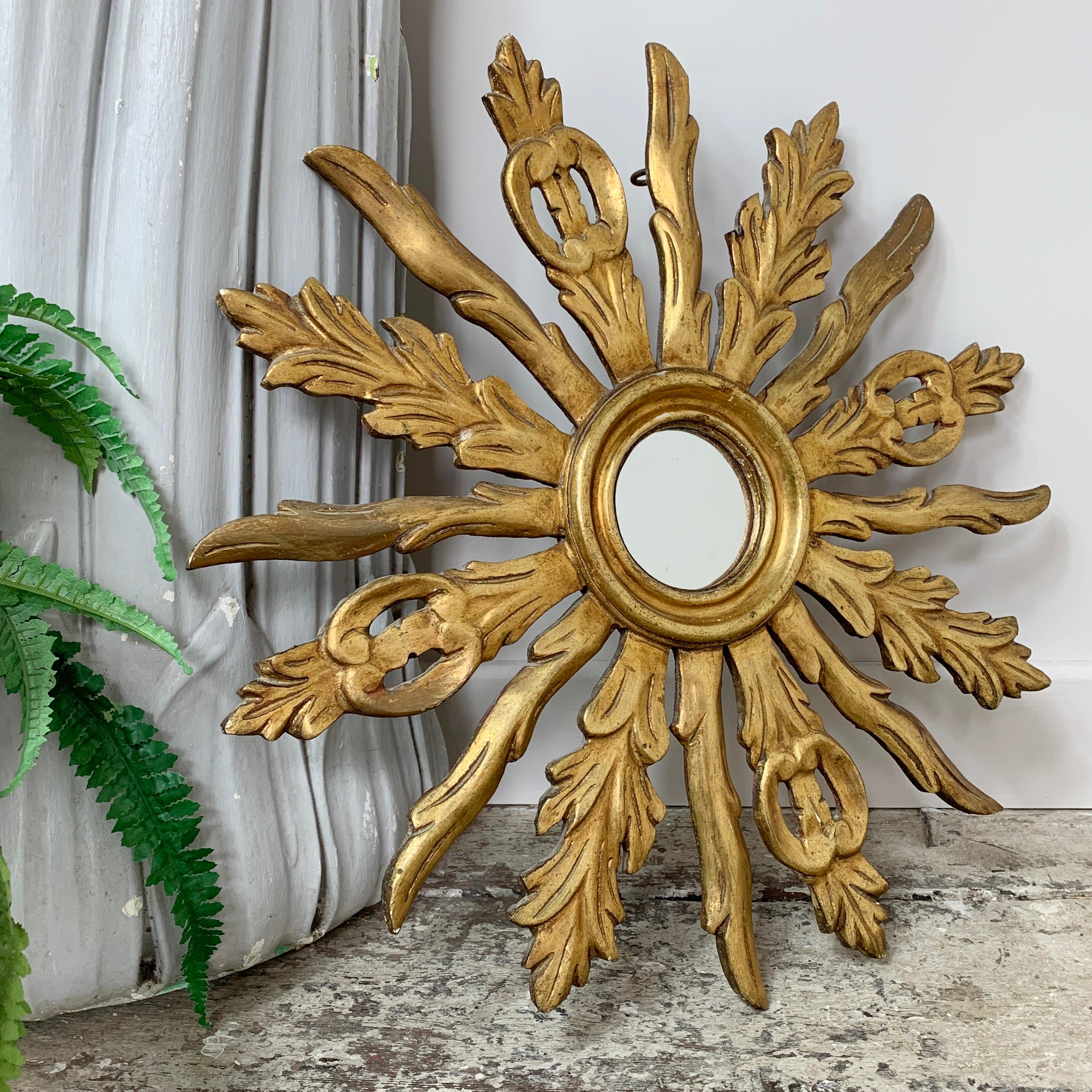 Ornately carved French wooden sunburst mirror, mid century, with beautiful original gilt finish
Measures: 50cm width/height, 3cm depth, mirror glass 8.5cm
Fabulous decorative shaping and design to the full rays, a very decorative sunburst
Hanging