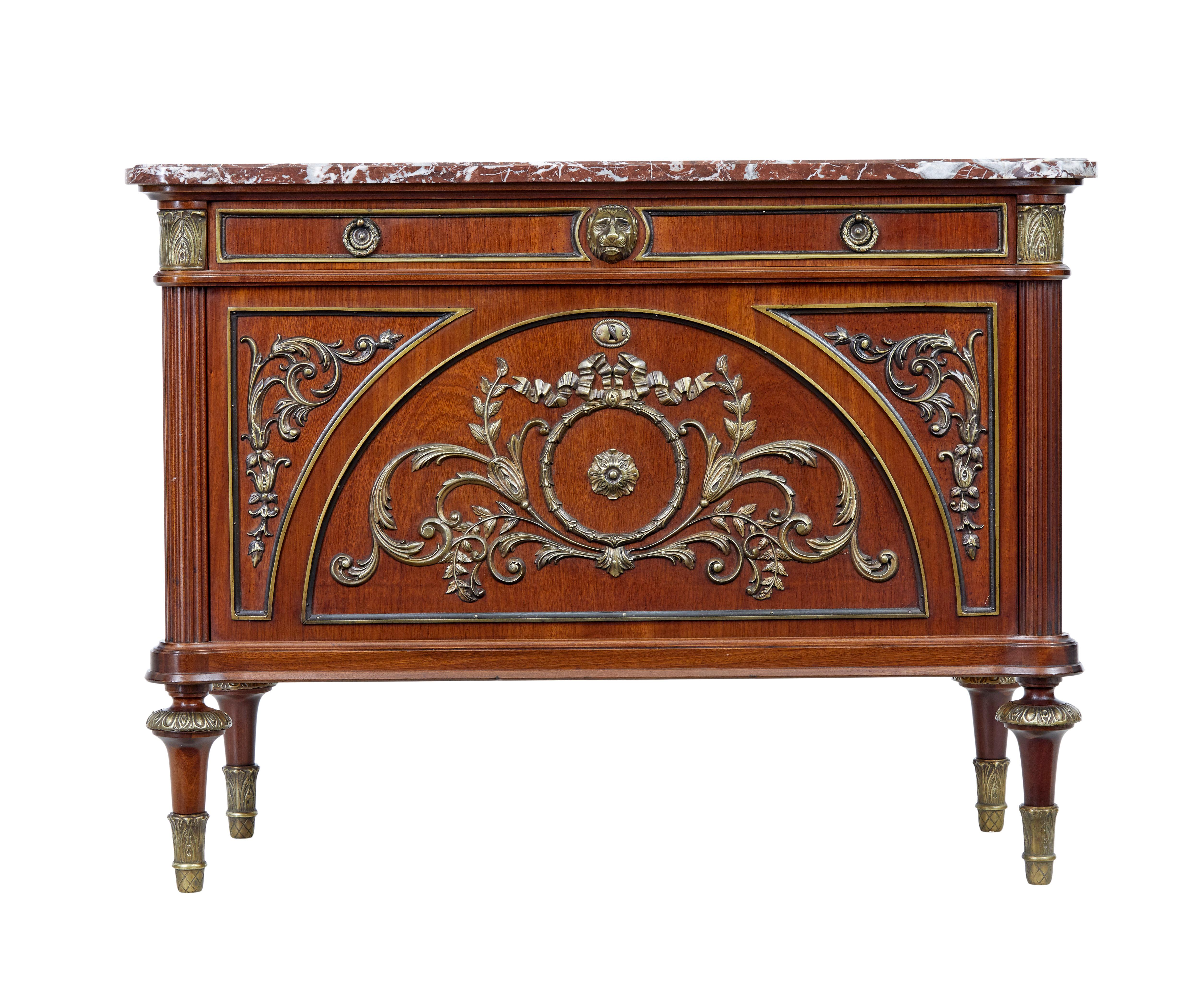 Fine quality 1960s ormolu, mahogany and marble top commode.

Single drawer below the top, with a drop down front that conceals 2 fitted drawers. Beautifully applied ormolu and brass decoration. Fluted columns to the sides.

Marble top is loose