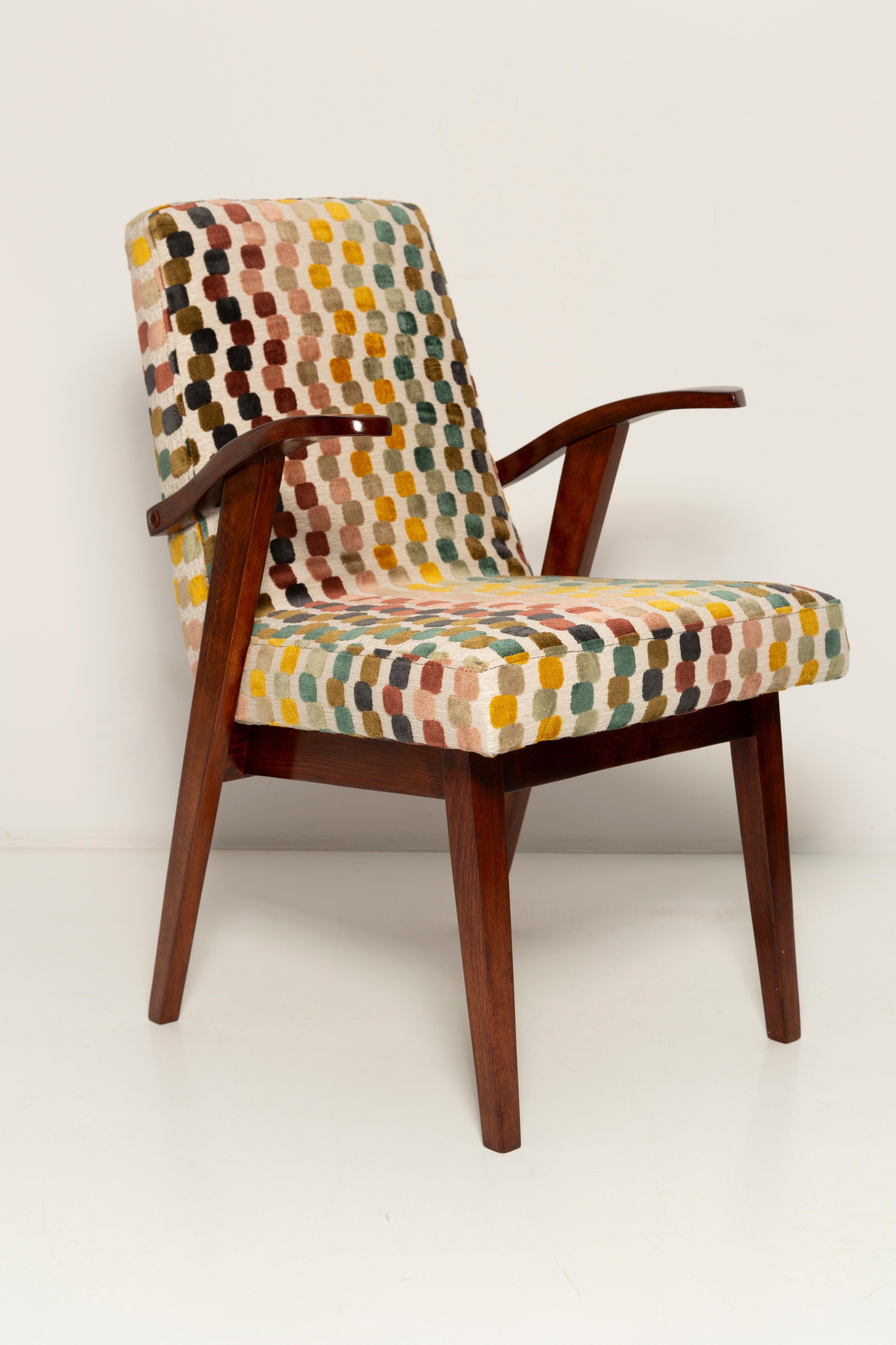 Armchair designed by Mieczyslaw Puchala. Dark brown wood combined with a beautiful french velvet gives it elegance and nobility. 

The chair has undergone a full carpentry and upholstery renovation. The wood is in excellent condition after full