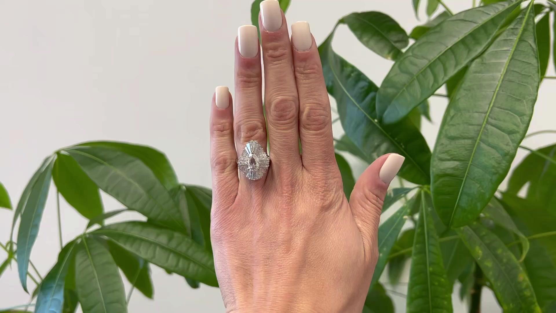 One Mid Century Oscar Heyman Bros GIA 1.01 Pear Cut Diamond Platinum Ballerina Ring. Featuring one GIA pear cut diamond of 1.01 carats, accompanied with GIA #6441874279 stating the diamond is H color, I2 clarity. Accented by 24 tapered baguette cut