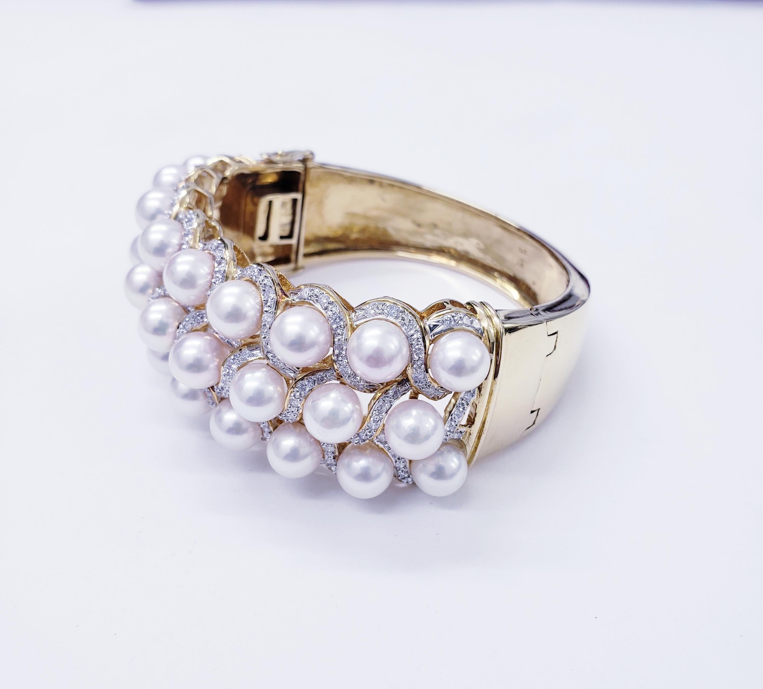 Mid Century Outstanding luxury diamonds and pearls bangle hand crafted in 18k yellow gold. The bangle features 26 Pearls measuring 7mm each. Diamonds VS/SI 4.00TCW 
Circa 1960s
