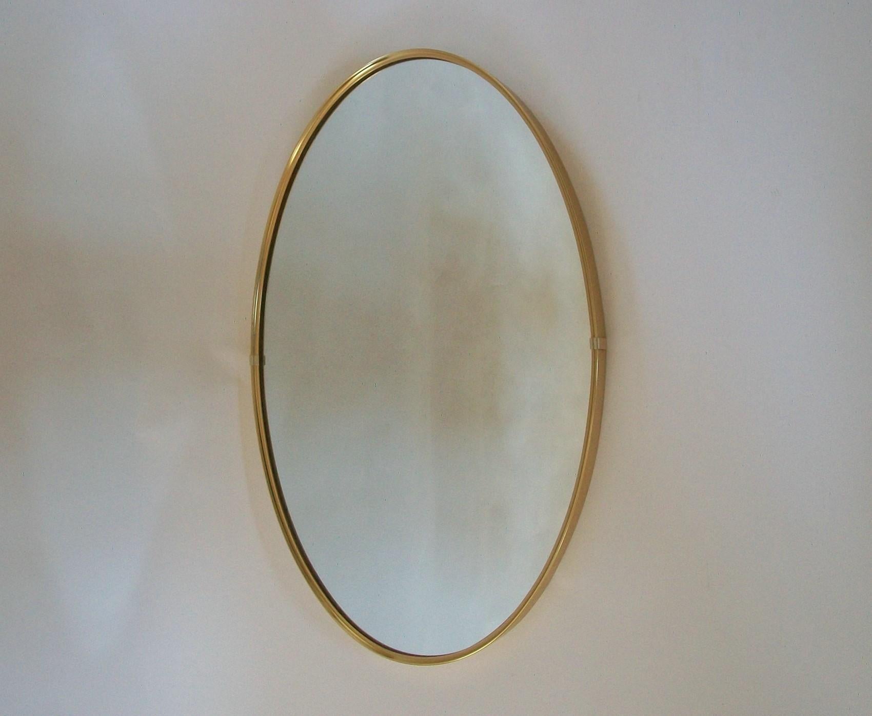 Mid-Century Modern brass framed oval mirror - exceptional quality - horizontal or vertical orientation - unsigned - Italy (likely) - circa 1970s.

Excellent vintage condition - no loss - no damage - no restoration - minor signs of age and