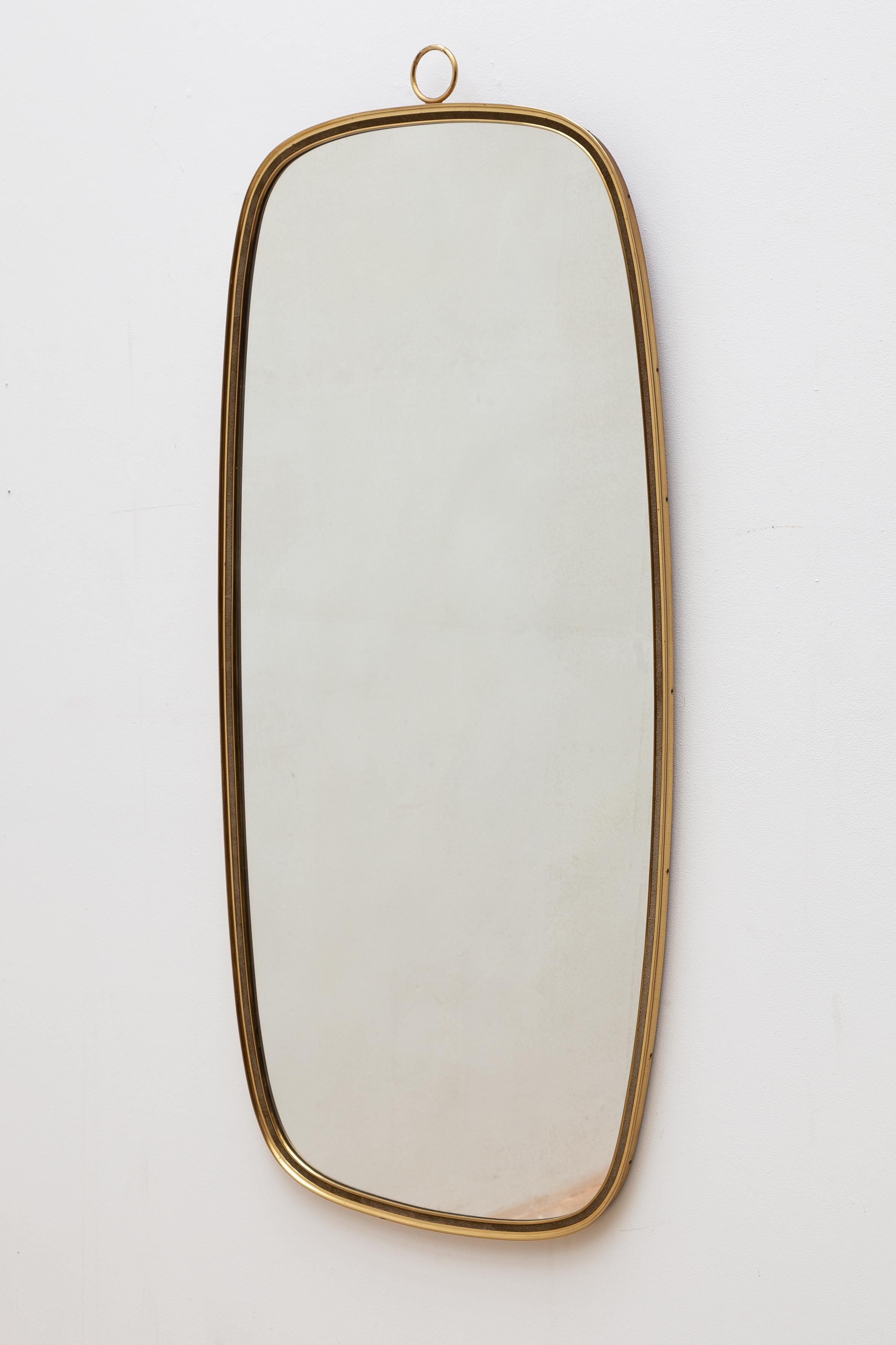 Vintage midcentury Italian wall mirror. Handsome oval brass frame. 
Dimensions: 54W x 128H x 2.5D cm.