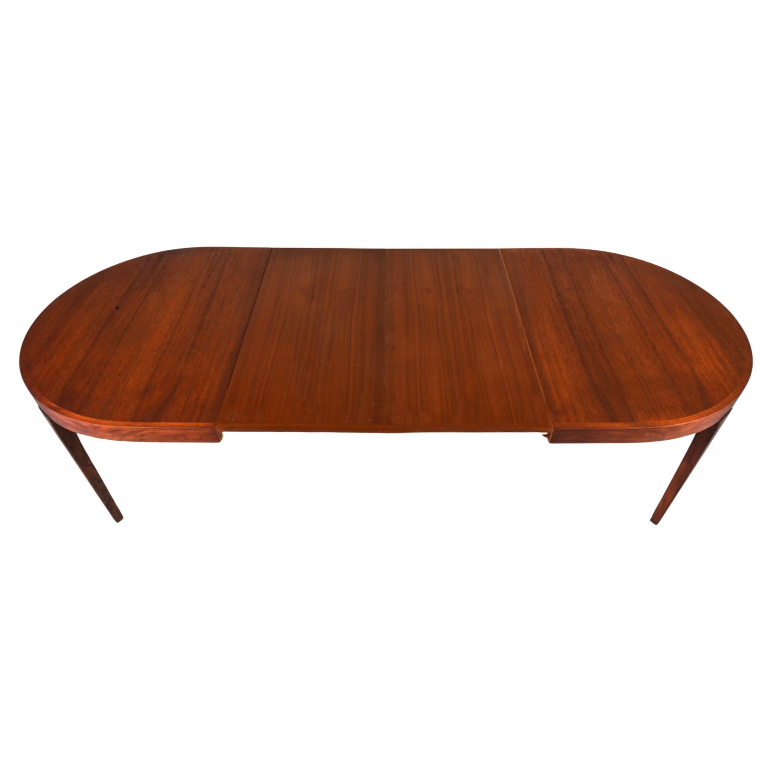 Stunning mid century Teak oval Danish Modern extension dining table with (2) flat leaves. By in the style of Kofod Larsen. This table is in beautiful condition with reddish brown teak tones very great modern Dining Table. high quality construction