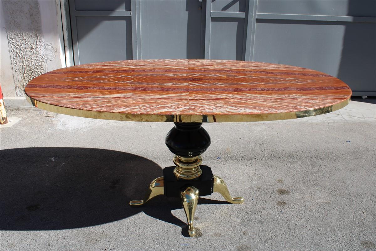 Very rare table from the 1950s, it can also be used as a boardroom table or in a hotel hall, the top made of Flamed Tanzanian onyx, with brass band, ebonized wood foot and parts in solid solid brass, the central stem in brass it has the MADE IN