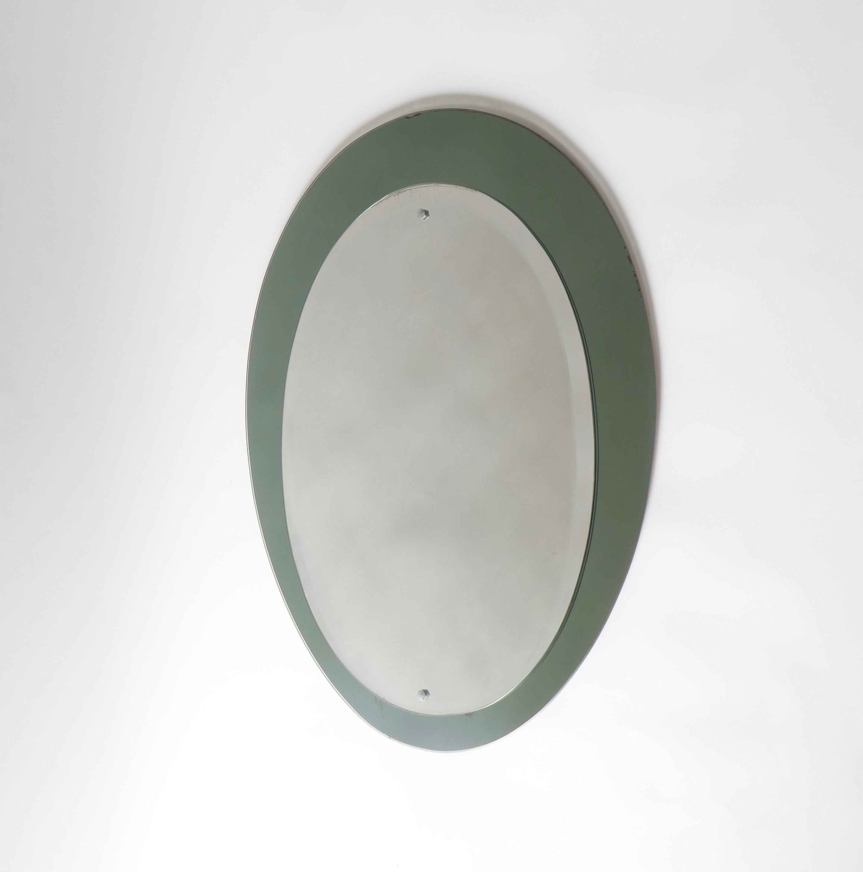 Mid-century oval mirror with a green smoked mirrored frame, Italy 
1960s.